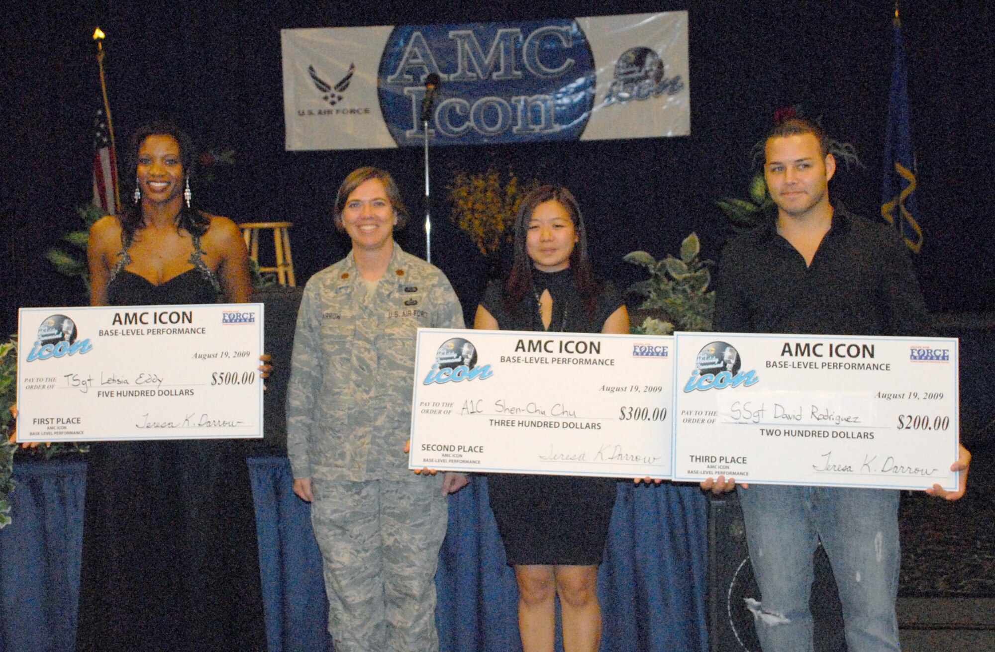 (Left to right) Tech. Sgt. Letisia Eddy, first place; Maj. Teresa Darrow, 436th Force Support Squadron commander; Airman 1st Class Shen-Chia Chu, second place; and Staff Sgt. David Rodriguez, third place, pose for a group shot after Dover's Air Mobility Command Icon contest Aug. 19 at The Landings Club. Sergeant Eddy will next compete at Scoot Air Force Base, Ill., against the top performers from other AMC Installations.  (U.S. Air Force photo/Airman 1st Class Matthew Hubby)