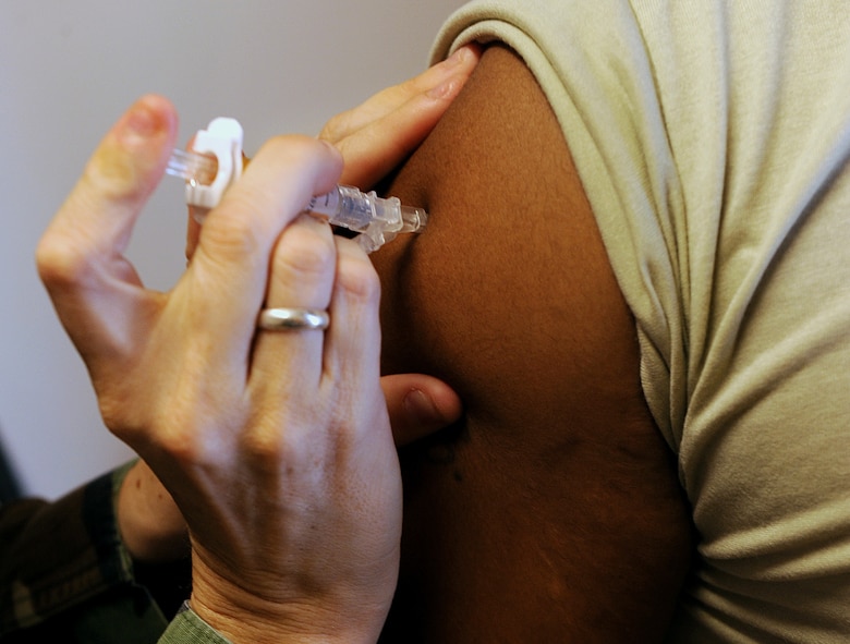 MOODY AIR FORCE BASE, Ga. -- Staff Sgt. Sasha Barker, 23rd Medical Group medical technician, administers an immunization shot to Staff Sgt. Lawrence Eakins, 23rd Mission Support Group assistant NCO in-charge, here Aug. 21. Sergeant Eakins is tasked to deploy in support of Operation Iraqi Freedom. (U.S. Air Force photo by Airman 1st Class Joshua Green)