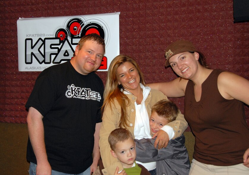 KFAT 92.9 FM Morning Chaos DJs Brad Erickson and Nikki Dellerman pose with Heather, James and Teddy Fussell following a Friday morning on-air interview highlighting the new Yellow Ribbon Reintegration Program. During the interview the Fussells were phoned-in with husband and father, Tech. Sgt. Ted Fussell, 477th Civil Engineer Squadron, who is deployed to Kirkuk Regional Air Base with other members of the 477th Fighter Group.  (Air Force Photo / Maj. Cary McPartlin)