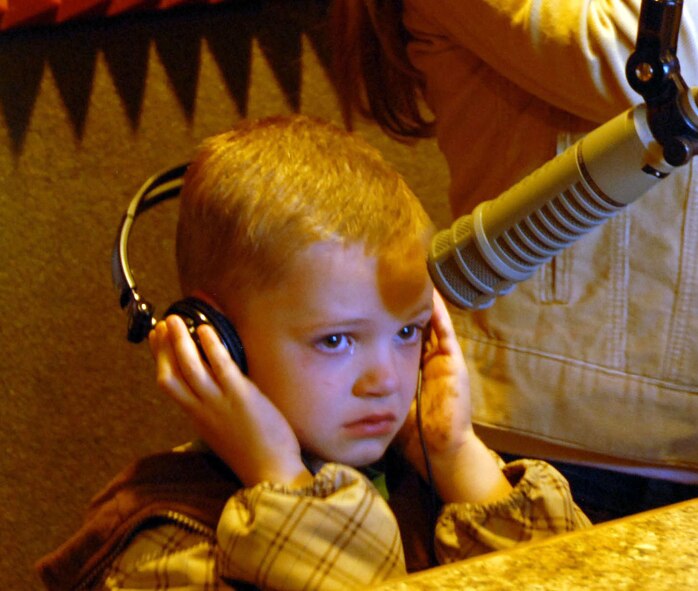 Five-year-old James Fussell tells his dad, Tech. Sgt. Ted Fussell, 477th Civil Engineer Squadron, how much he misses him during a KFAT 92.9 FM Morning Chaos interview.  Tech. Sgt.  Fussell is one member of the 477th CES who is currently deployed to Kirkuk Regional Air Base, with other members of the 477th FG, helping rebuild roads and mosques and train local Iraqi nationals in construction.  (Air Force Photo / Donna Gindle)