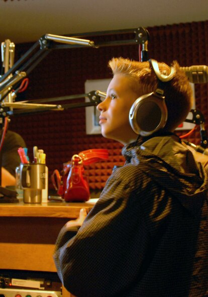 Teddy Fussell, 8, waits to hear his dad's voice during a KFAT 92.9 FM Morning Chaos radio interview Friday morning. His dad, Tech. Sgt. Ted, Fussell, 477th Civil Engineer Squadron, is deployed to Kirkuk Regional Air Base with other members of the 477th Fighter Group, helping rebuild roads and mosques and train local Iraqi nationals in construction.  (Air Force Photo / Donna Gindle)