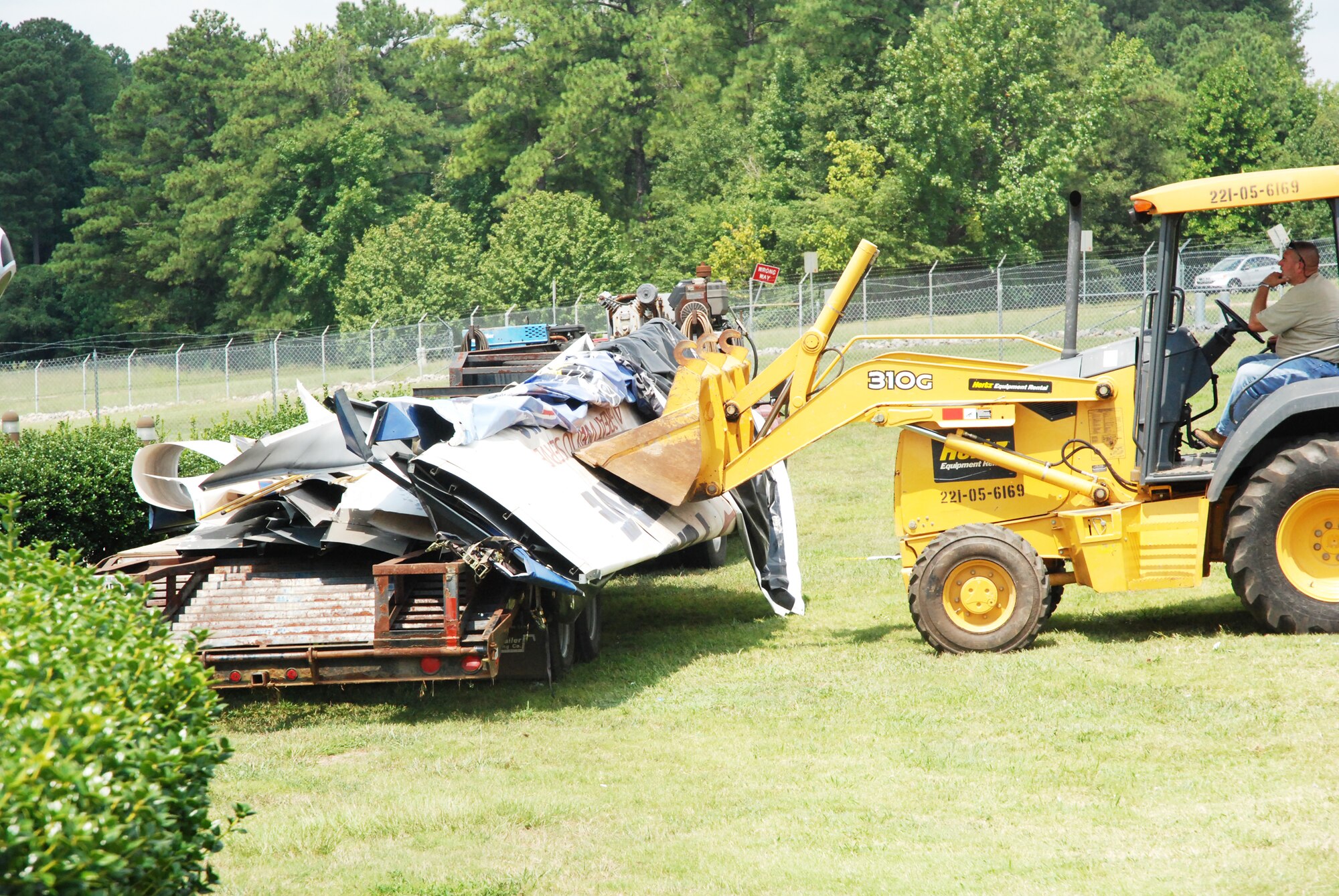 Contractors load pieces of the Dobbins 2008 Air Show billboard is onto a flat bed truck to be hauled away Aug. 24. (U.S.Air Force photo/Kennith Green)