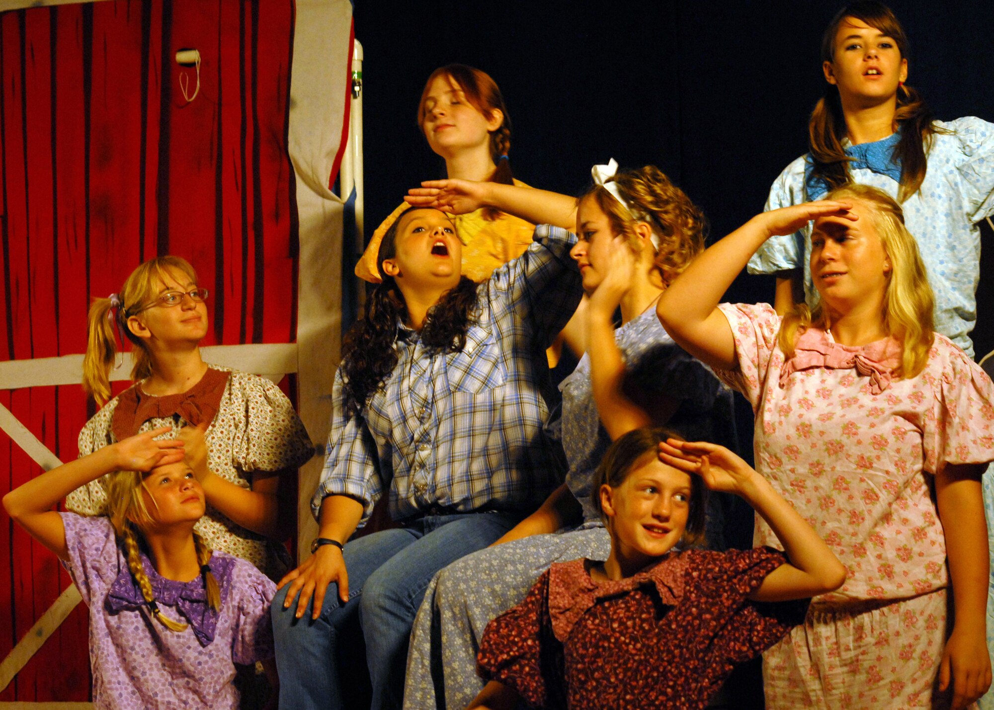 Left to Right;  Maci Moore,  Rebecca Jones,  Christy Waymouth, Katheryn Left to Right;  Maci Moore,  Rebecca Jones,  Christy Waymouth, Katheryn Rearick, Alisha Kalder,  Annie Killlgore, Carline Jones and Brittnee Kalder perform in Beauty Lou and the Country Beast, at the Goodfellow AFB base theater Aug. 14. The Missoula Children's Theatre provides a week-long performance workshop and rehearsals that culminate in two full-scale musical public performances starring almost 60 Goodfellow youth. (U.S. Air Force / Robert D. Martinez)