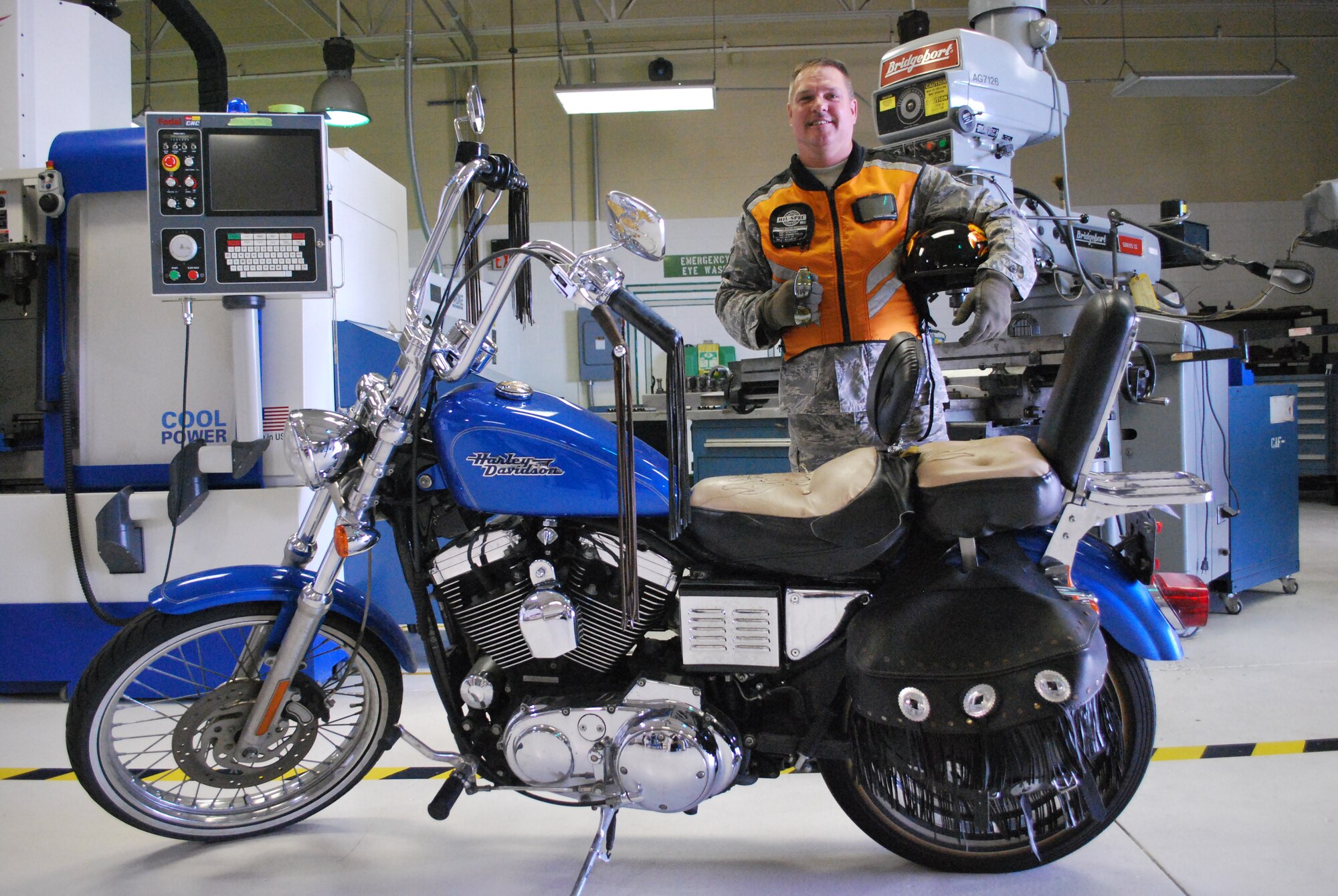 Tech. Sgt. Dave Miller, a machinist with the 433rd Fabrication Flight, is the Alamo Wing's motorcycle safety program coordinator. Sergeant Miller is an experienced rider who averages about 750 miles each weekend on his motorcycle. He is displaying the minimum safety gear a rider should use including; helmet, eye protection, reflective vest and gloves. Sergeant Miller is also one of the Motorcycle Safety Foundation Basic Riding Course instructors at Lackland Air Force Base. The class is required of all riders before riding their bikes on base. (U.S. Air Force Photo/Master Sgt. Collen McGee)