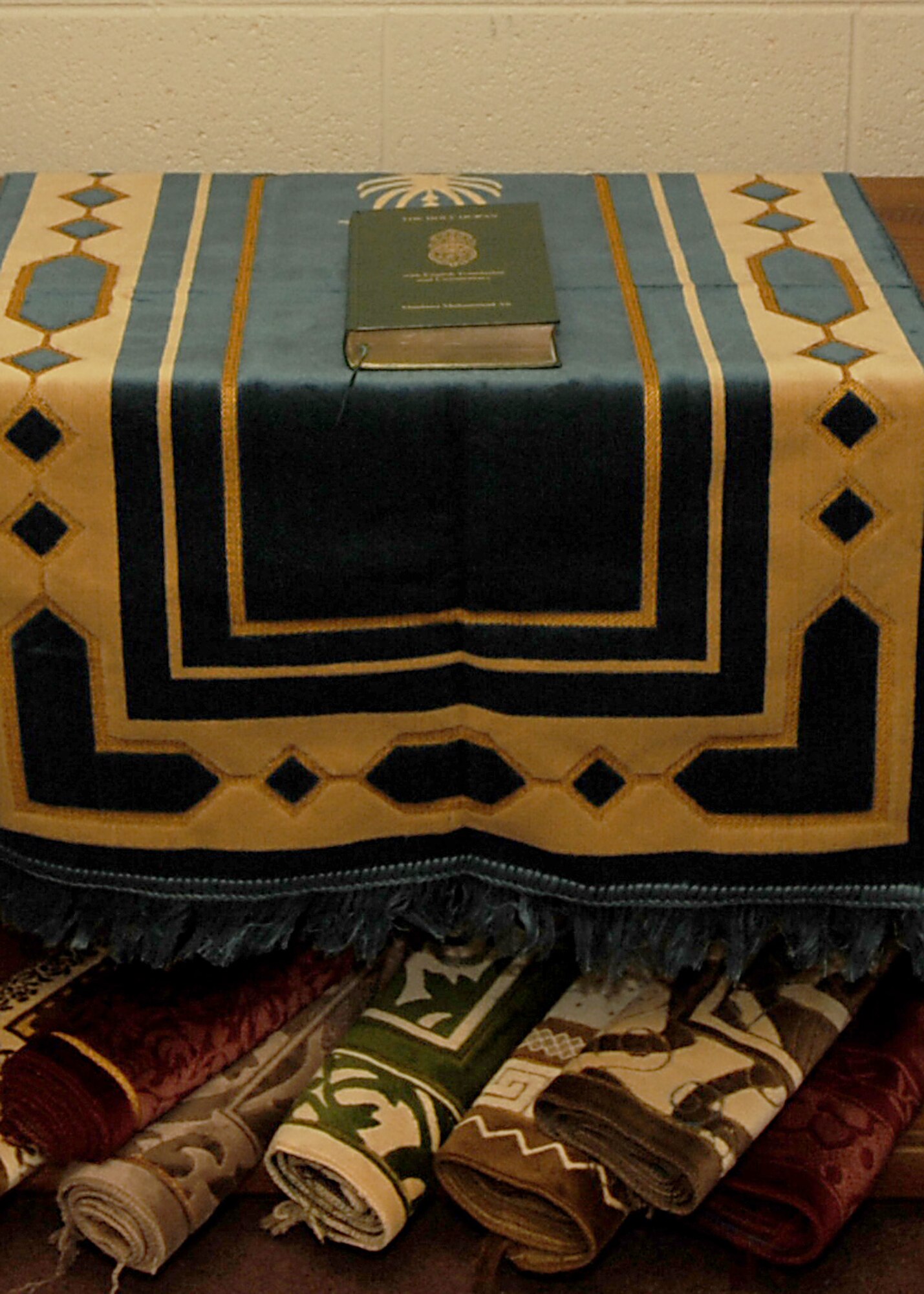 NELLIS AIR FORCE BASE NEV.,--The Qu'ran, the Muslim Holy book, sits on display with several prayer rugsat the new Muslim Worship Center, located in the Nellis Base Chapel.  The room was constructed to provide Muslim servicemembers a place to worship during the Muslim holy season of Ramadan.
(U.S. Air Force Photo / Airman 1st Class Jamie Nicley)