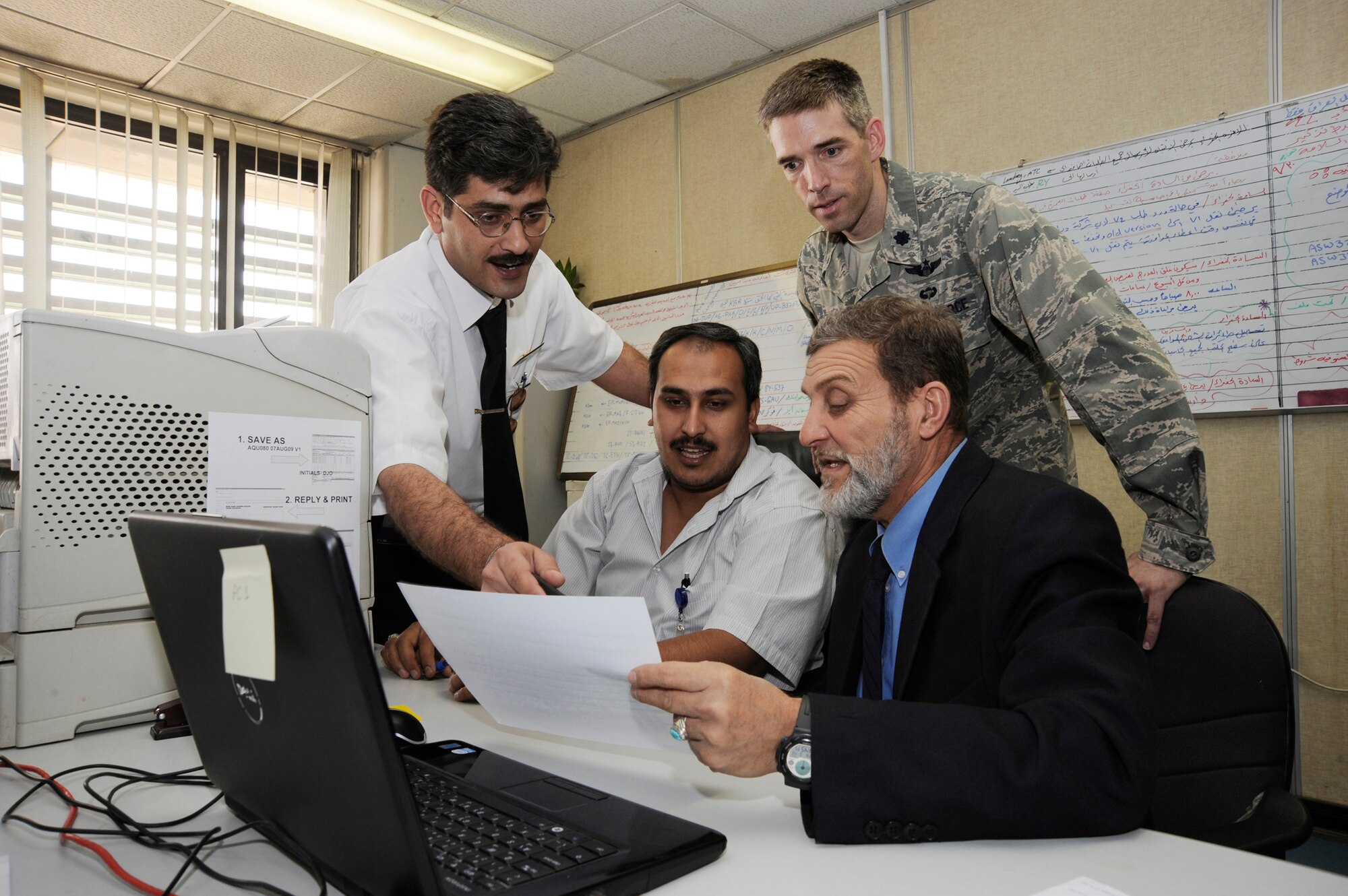 Lt. Col. Dan Oosterhous observes while members of the Iraqi civil aviation authority demonstrate their ability to properly approve and disapprove civil aircraft flights throughout Iraq Aug. 20 in Baghdad. Colonel Oosterhous is the Regional Air Movement Control Center chief assigned to the Combined Air Operations Center in Southwest Asia, and is deployed from Scott Air Force Base, Ill. He is a native of Texarkana, Ark. (U.S. Air Force photo/Tech. Sgt. Johnny L. Saldivar) 