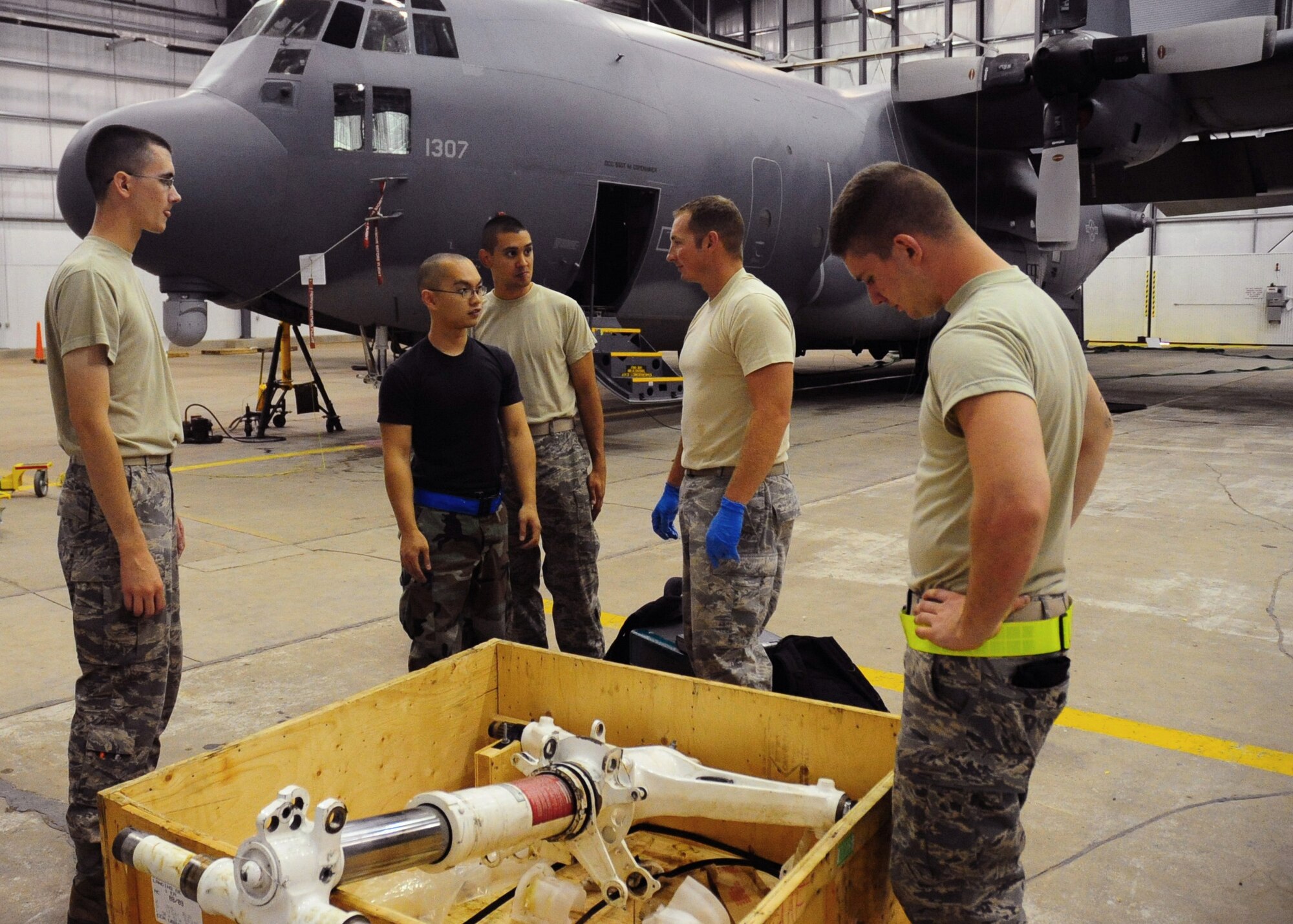 CANNON AIR FORCE BASE, N.M. -- Airmen from the 27th Special Operations Aircraft Maintenance Squadron and 27th Special Operations Equipment Maintenance Squadron discuss the procedures of changing a nose end strut on a C-130W Combat Talon here, Aug. 20. This is the first time the maintenance squadrons changed a nose end strut at Cannon. (U.S. Air Force photo/ Senior Airman Erik Cardenas) 