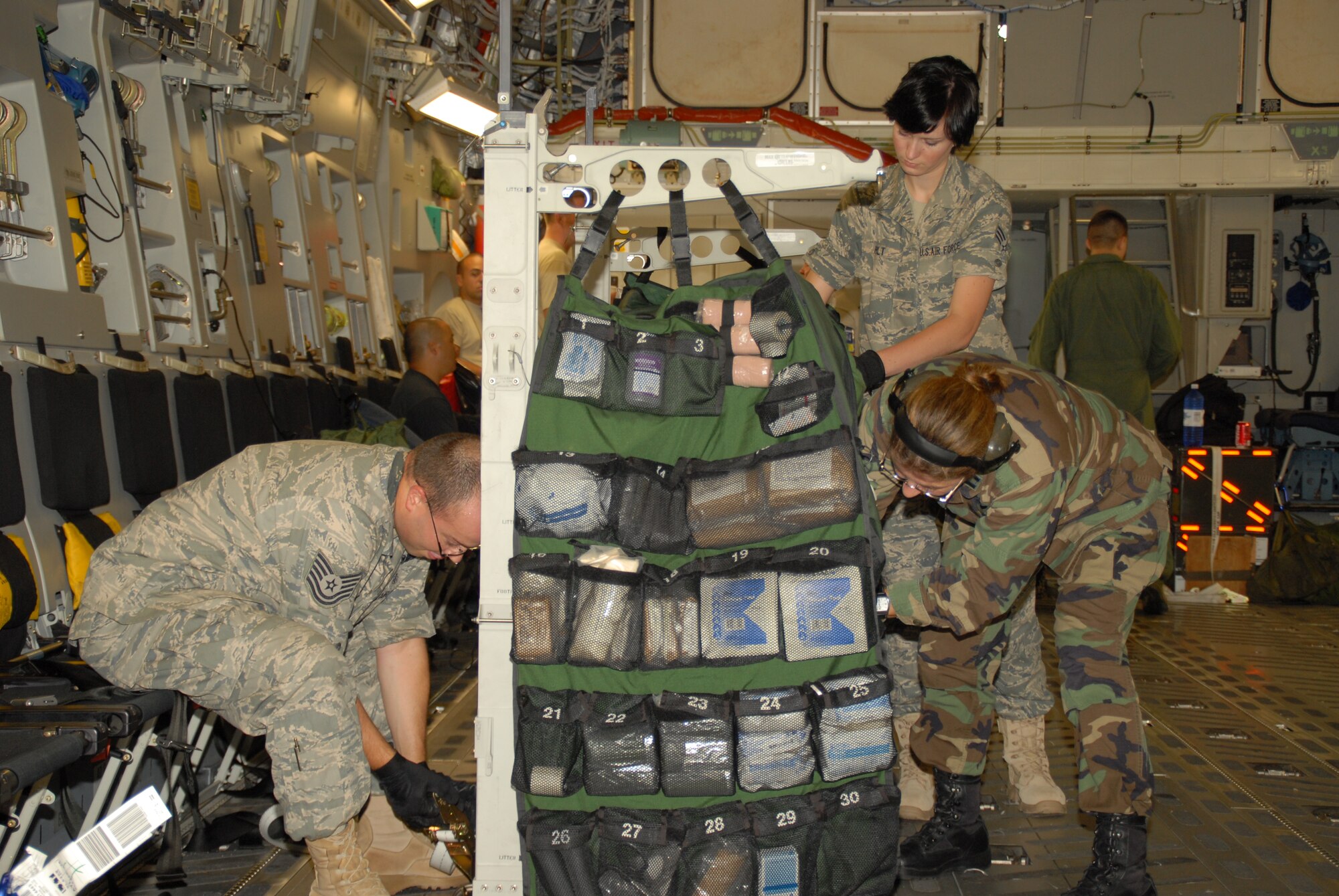 Airmen from the 43rd Aeromedical Evacuation Squadron at Pope Air Force Base, N.C., configure litters and equipment aboard a C-17 Globemaster III during a Joint Readiness Training Center Exercise 09-09 training mission on Aug. 19, 2009, at Little Rock Air Force Base, Ark.  The JRTC, located at Fort Polk, La., provides realistic training using war-time scenarios that allow integration between joint military organizations, host nations and civilian role-players. Units from the Air Force, Army and from the Canadian and Belgian air forces are training together during the 09-09 exercise.  (U.S. Air Force Photo/Capt. Joe Knable)