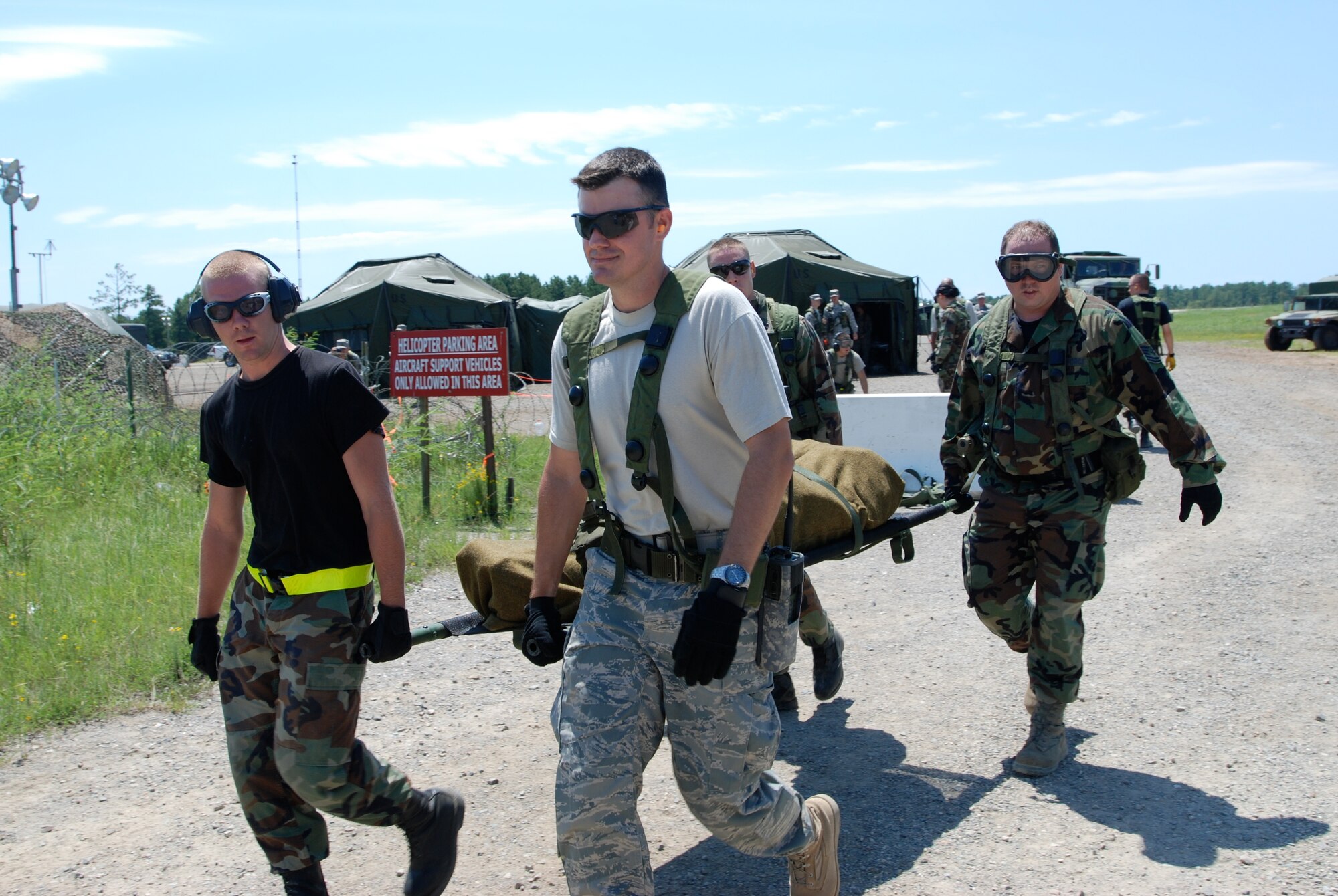Members of a contingency response element from the 819th Global Support Squadron, 621st Contingency Response Wing of Joint Base McGuire-Dix.Lakehurst, N.J., assist aeromedical evacuation Airmen carry a mock patient to a C-17 Globemaster III during a training AE mission at the Joint Readiness Training Center Exercise 09-09 at Fort Polk, La., on Aug. 22, 2009.  JRTC provides realistic training using scenarios that allow integration between joint military organizations, host nations and civilian role-players. Units from the U.S. Air Force, Army and the Canadian and Belgian air forces are training together during the exercise.  (U.S. Air Force Photo/Bekah Clark)