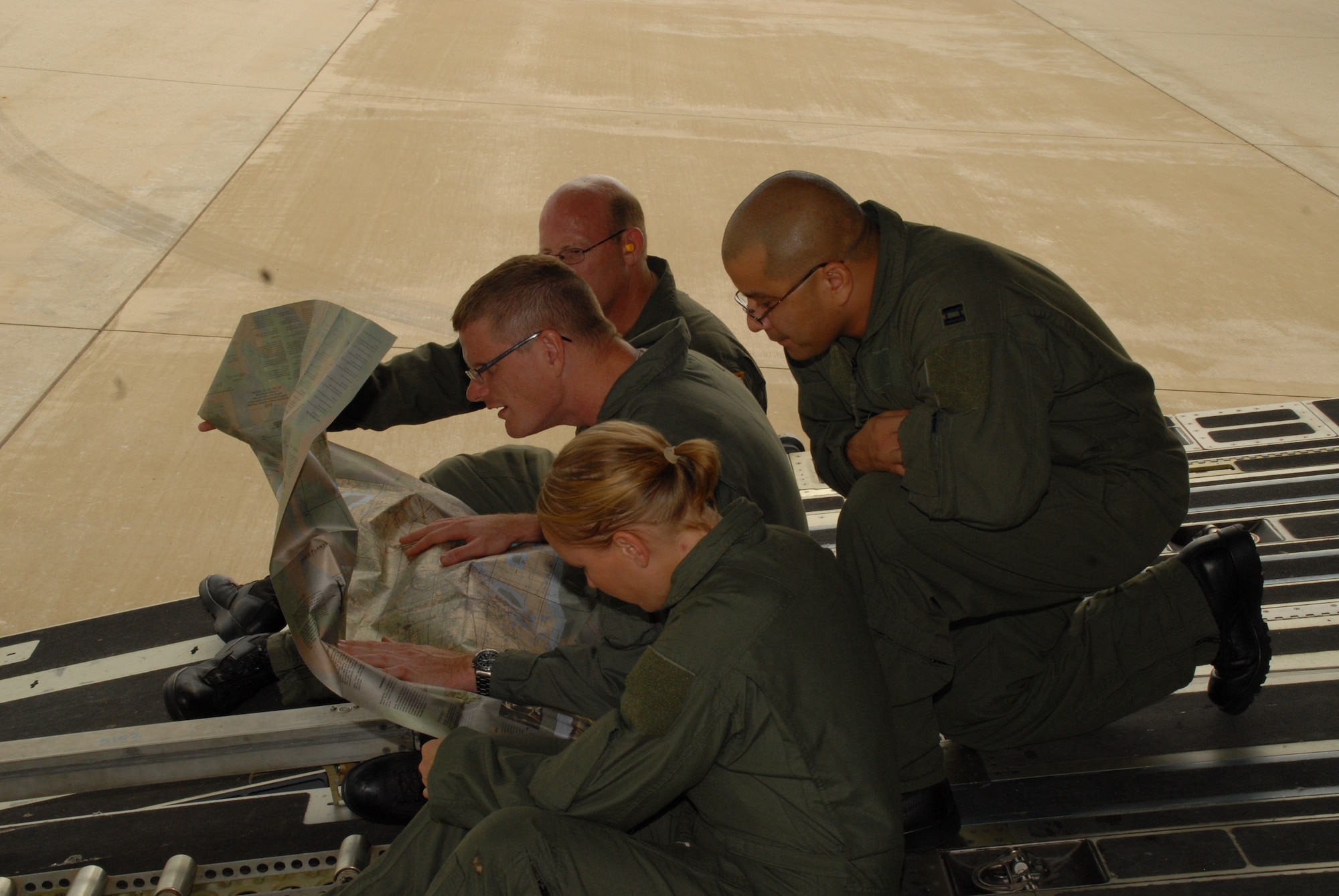 Airmen from the 43rd Aeromedical Evacuation Squadron at Pope Air Force Base, N.C., study a terrain survival map aboard a C-17 Globemaster III during a training mission Aug. 19, 2009, at Little Rock Air Force Base, Ark., as part of Joint Readiness Training Center Exercise 09-09.  The Joint Readiness Training Center, located at Fort Polk, La., provides realistic training using scenarios that allow integration between joint military organizations, host nations and civilian role-players. Units from the Air Force, Army and the Canadian and Belgian air forces are training together during JRTC Exercise 09-09.   (U.S. Air Force Photo/Capt. Joe Knable)
