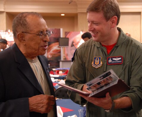 Retired Lt. Col. James Warren, one of the original Tuskegee Airmen, swaps flying stories with Maj. Kevin Sutterfield of the 302nd Fighter Squadron during the Tuskegee Airmen's 38th Annual National Convention Aug. 6, 2009. Colonel Warren is the honorary commander of the Air Force Reserve Command's 477th Fighter Group, Elmendorf Air Force Base, Alaska, and a former member of the 477th Bombardment Group. The 477th BG activated during World War II as part of the historic Tuskegee Airmen. The group was reactivated in 2007 when the 477th Fighter Group became the Air Force Reserve Command's first F-22 Raptor unit. (U.S. Air Force photo/Maj. Cary McPartlin)