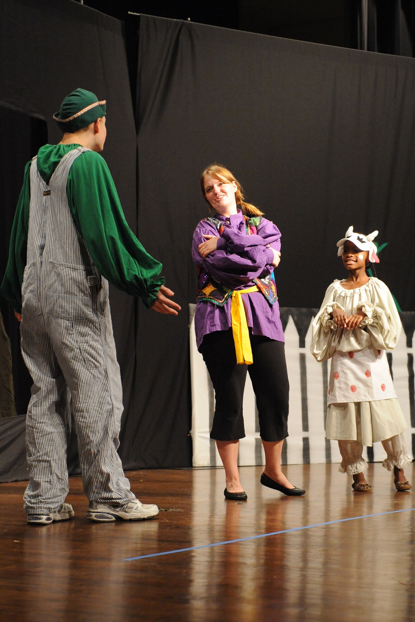 Liz Pascoe, a magic tour actor and director, tries to persuade  Jack to sell Milky White to the circus for eight magical beans during a "Jack and the Beanstalk" performance  at Seymour Johnson's base theater Aug. 15, 2009. The magical beans are supposed to lead Jack to new friends and riches so he can take care of his family. The directors support the development of lifeskills in children through participation in the performing arts. (U.S. Air Force photo by Airman 1st Class Whitney S. Lambert)