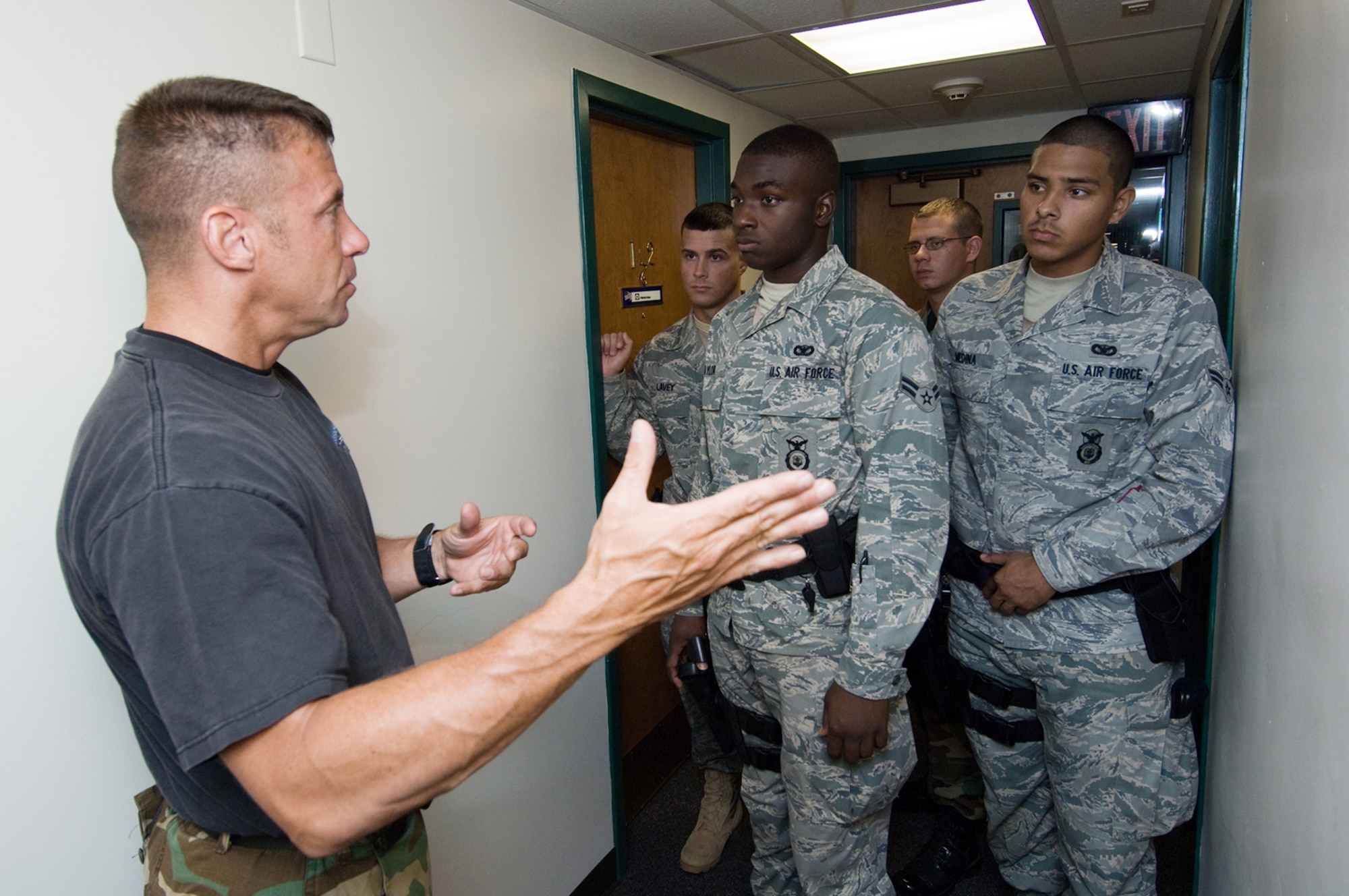Jim O'Donnell (from left to right) gives Airman 1st Class Jeffrey Lavey, Airman 1st Class Nicholas Taylor, Staff Sgt. Christopher Darrow and Airman 1st Class Abraham Medina instruction on neutralizing an active shooter within the dormitories during training Aug. 6 at Hanscom Air Force Base, Mass. Trooper O'Donnell is a member of the Massachusetts State Police Special Tactical Operations Team. The Airmen are assigned to the 66th Security Forces Squadron. (U.S. Air Force photo/Rick Berry)