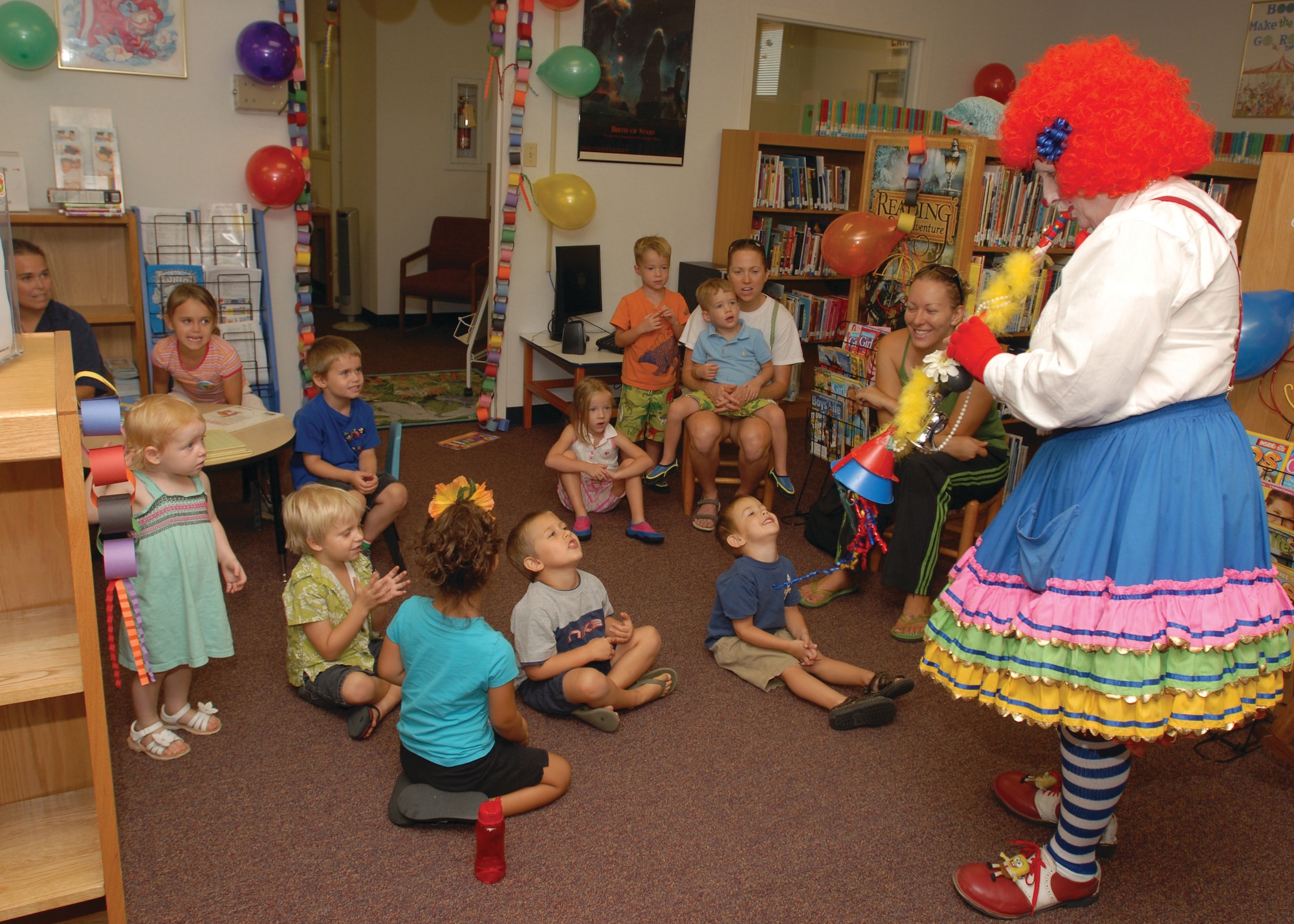 Children in the Summer Reading program sing along as Piccolo the Clown Performs “Twinkle, Twinkle, Little Star” at the Goodfellow library Aug. 14. (U.S. Air Force photo by Airman Clayton Lenhardt)