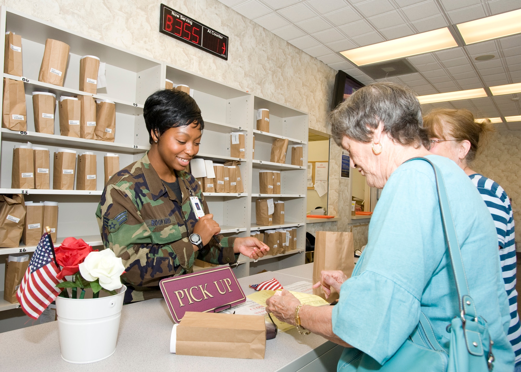 Senior Airman Maya Rookard, 96th Medical Support Squadron, helps customers at the front counter of the satellite pharmacy at Eglin Air Force Base Aug. 20.  The pharmacy is expanding 25 percent or 2,200 square feet to accommodate for new product and customer demand.  The 96th MDS has said that during the renovation, there should be no delays in customer service.  (U.S. Air Force photo/Craig McDonnell.)