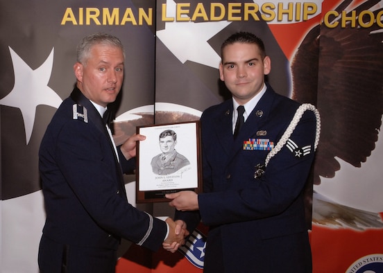SPANGDAHLEM AIR BASE, Germany -- Senior Airman Kyle Beard, 52nd Security Forces Squadron, receives the John L. Levitow award from Col. Kevin Anderson, 52nd Fighter Wing vice commander, during Airman Leadership School Class 09-7 graduation Aug. 19.  The John L. Levitow Award is the highest award a student can receive in the five-week class, and it recognizes the Airman’s  ability as a leader and a scholar.  (U.S. Air Force photo/Staff Sgt. Logan Tuttle)