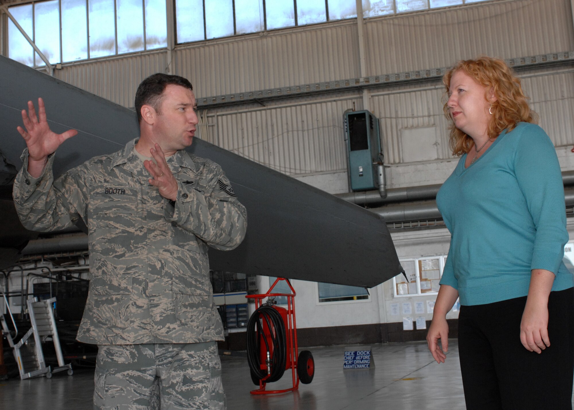 SPANGDAHLEM AIR BASE, Germany -- Tech. Sgt. Joel Booth, 52nd Equipment Maintenance Squadron F-16 Inspection Section chief, gives a maintenance brief to Kris Mallard, staff delegate for the U.S. House Appropriations Committee-Defense Aug. 19. Ms. Mallard visited Spangdahlem to view the F-16 Fighting Falcon and A-10 Thunderbolt II, as well as discuss the functionality of the aircraft. (U.S. Air Force photo/ Senior Airman Jenifer H. Calhoun)