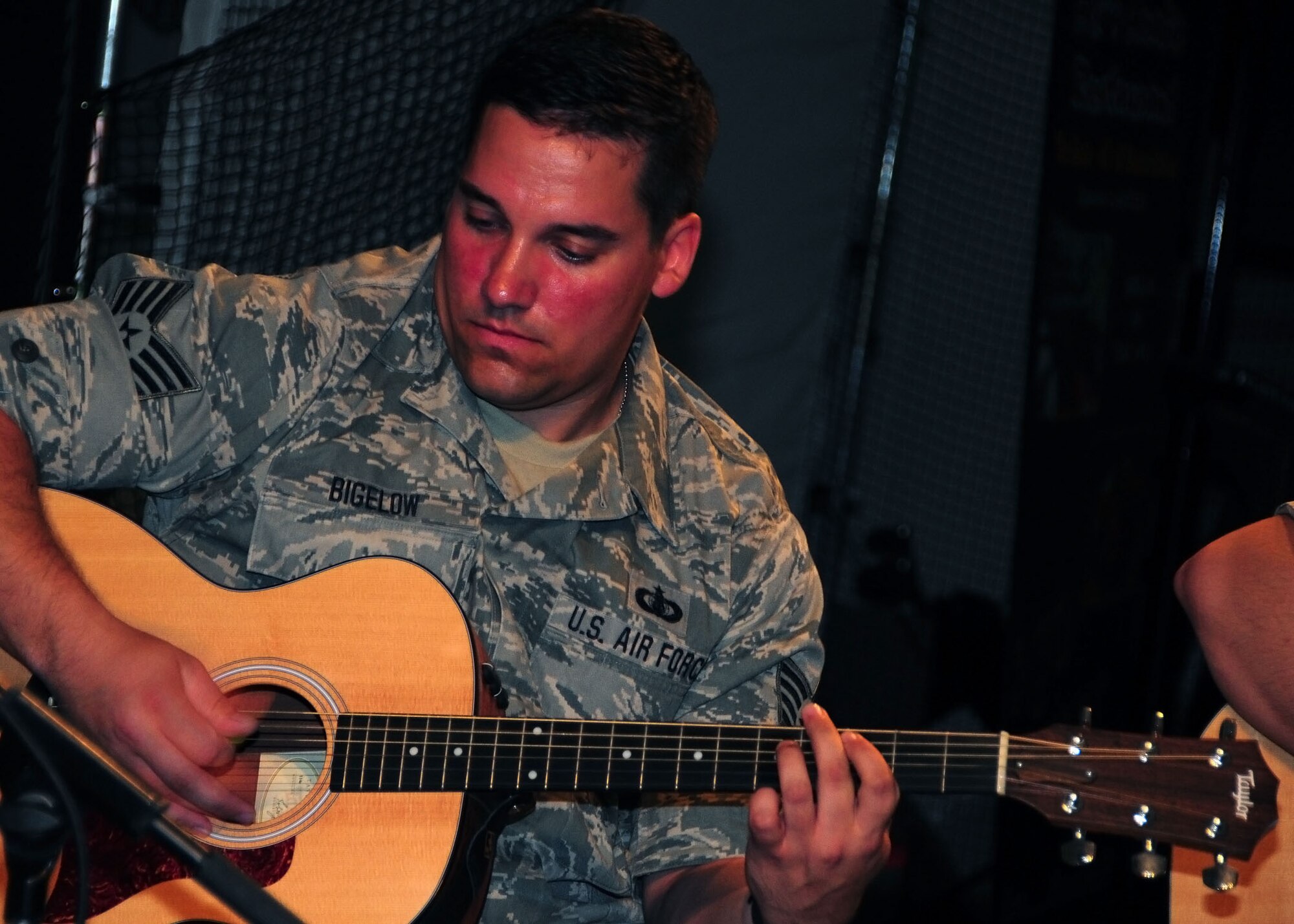 SOUTHWEST ASIA -- Staff Sgt. Brian Bigelow, Air Force Central Command Mojave band, plays the guitar during a performance for the 386th Air Expeditionary Wing at an undisclosed location in Southwest Asia Aug. 22, 2009.  Mojave is a deployed band comprised of Airmen from the 180th Fighter Wing, Toledo, Ohio.  Sergeant Bigelow hails from Jacksonville, Fla.  (U.S. Air Force photo / Tech Sgt. Tony Tolle)