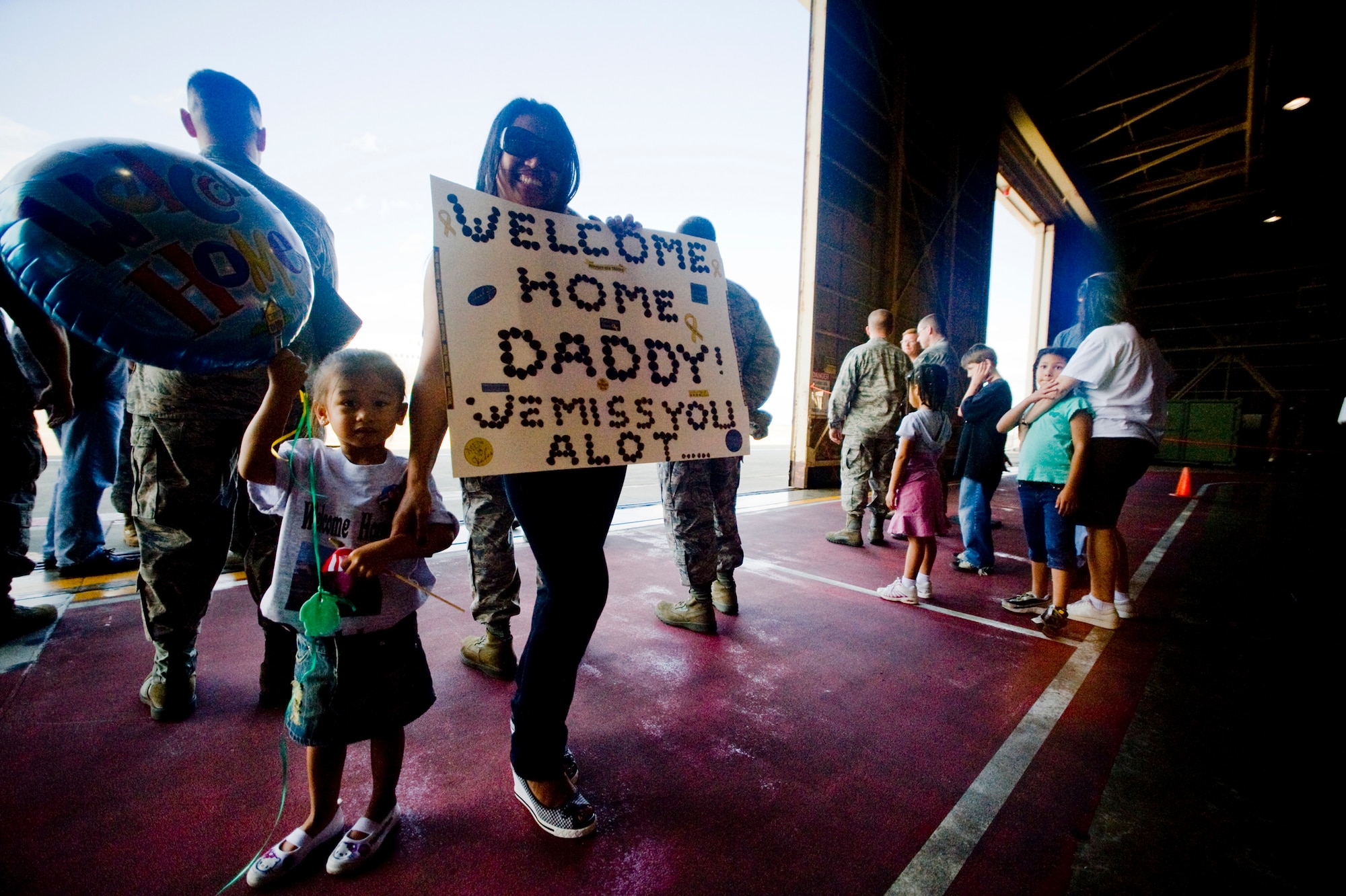 MISAWA AIR BASE, Japan -- Sharon and Alayna Refugio await the arrival of their loved one Aug. 23 at Hangar 949. The two are wife and daughter of Staff Sgt. Marlon Refugio, who deployed to Suwon Air Base, South Korea, for six months. (U.S. Air Force photo/Senior Airman Jamal D. Sutter)