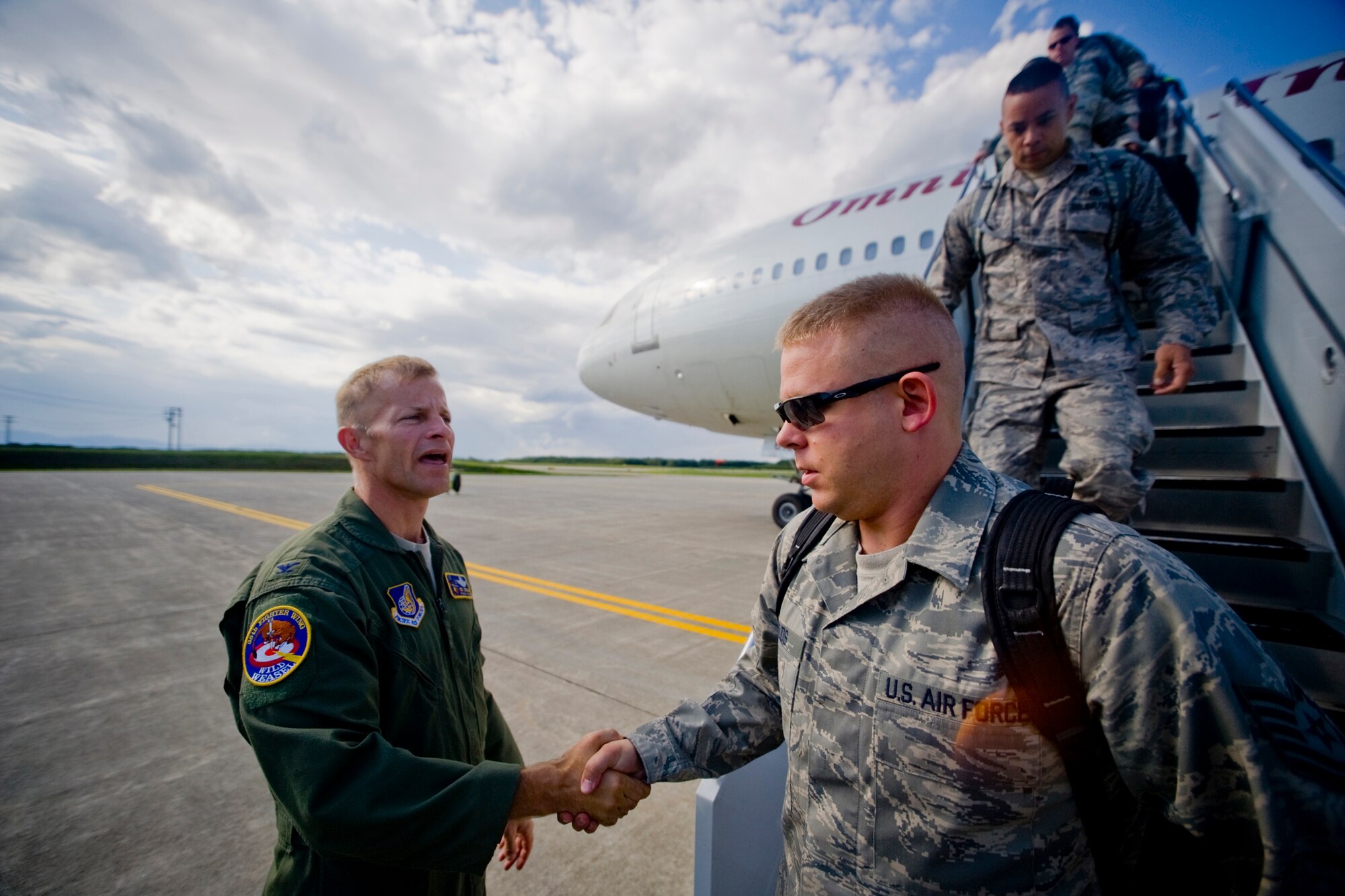 MISAWA AIR BASE, Japan -- Col. RC Craig, 35th Fighter Wing vice commander, welcomes members of the 13th Aircraft Maintenance Unit, 35th Aircraft Maintenance Squadron and 35th Maintenance Squadron Aug. 23. The squadrons supported and helped maintain the 13th Fighter Squadron and its efforts during a deployment to Suwon Air Base, South Korea. (U.S. Air Force photo/Senior Airman Jamal D. Sutter)