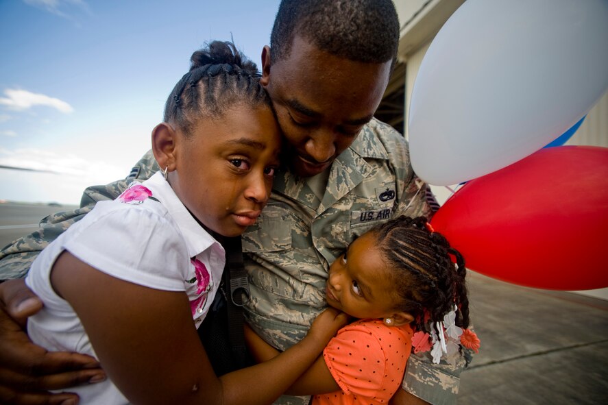 MISAWA AIR BASE, Japan -- Jaida and Jhamia White welcome their father, Tech. Sgt. Dexter White, 13th Aircraft Maintenance Unit, upon return from deployment Aug. 23. Sergeant White, along with members of his unit, supported the 13th Fighter Squadron during a deployment to Suwon Air Base, South Korea. (U.S. Air Force photo/Senior Airman Jamal D. Sutter)