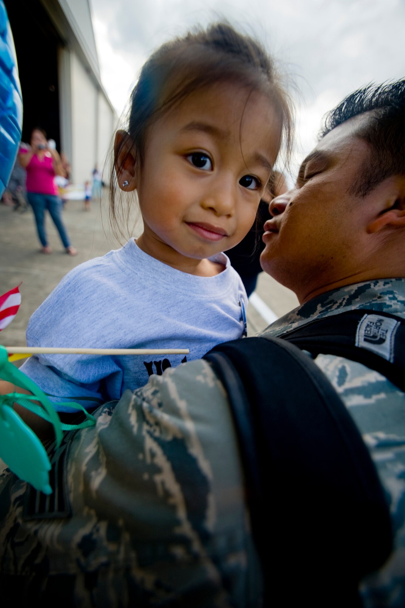 MISAWA AIR BASE, Japan -- Staff Sgt. Marlon Refugio, 13th Aircraft Maintenance Unit, hugs his daughter, Alayna, after returning from deployment Aug. 23.  Friends, family and co-workers gathered at Hangar 949 to greet the returning Airmen who deployed to Suwon Air Base, South Korea. (U.S. Air Force photo/Senior Airman Jamal D. Sutter)