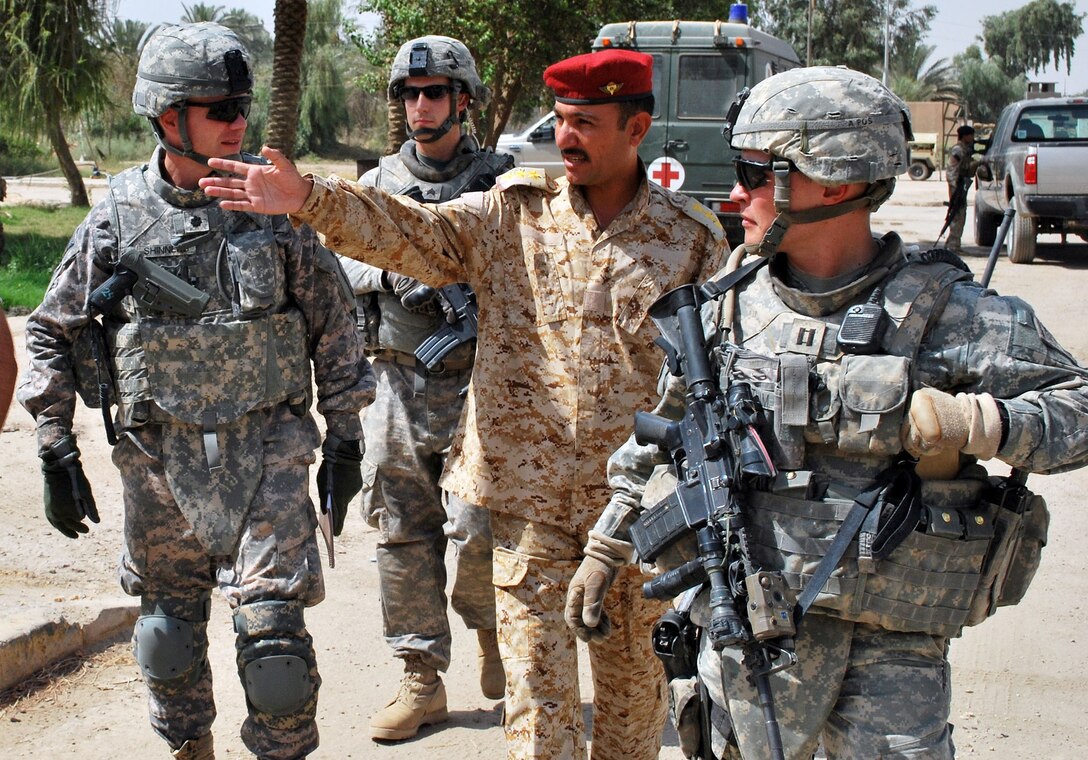 An Iraqi army officer speaks with U.S. Army Lt. Col. Michael Shinners, left, and U.S. Army Capt. Dallas Cheatham, right, about the history of the Taq-i-kisra Arch and the area that surrounds it, Aug. 5, 2009. Shinners is the deputy commander for the 82nd Airborne Division’s 3rd Brigade Combat Team. Cheatham is commander of the brigade’s Company B, 1st Battalion, 505th Parachute Infantry Regiment. U.S. Army photo by Pvt. Jared Gehman