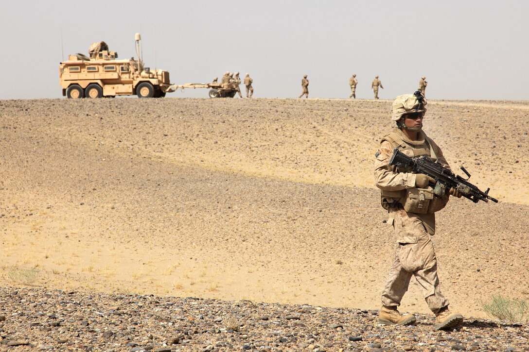 U.S. Marine Corps Cpl. William Medina walks through the desert during a census patrol in Helmand province, Afghanistan, Aug. 18, 2009. Medina is a amphibious assault vehicle crewman assigned to Delta Company, 2nd Amphibious Assault Battalion, 2nd Marine Expeditionary Brigade.