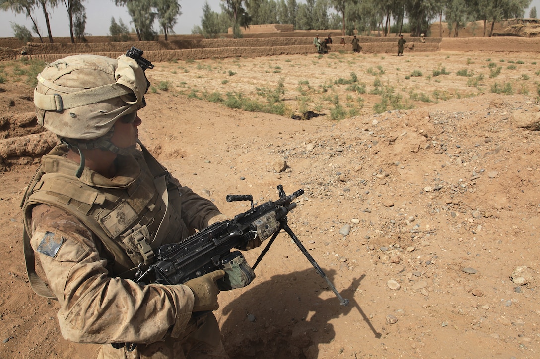 U.S. Marine Corps Cpl. William Medina maintains security during a ...