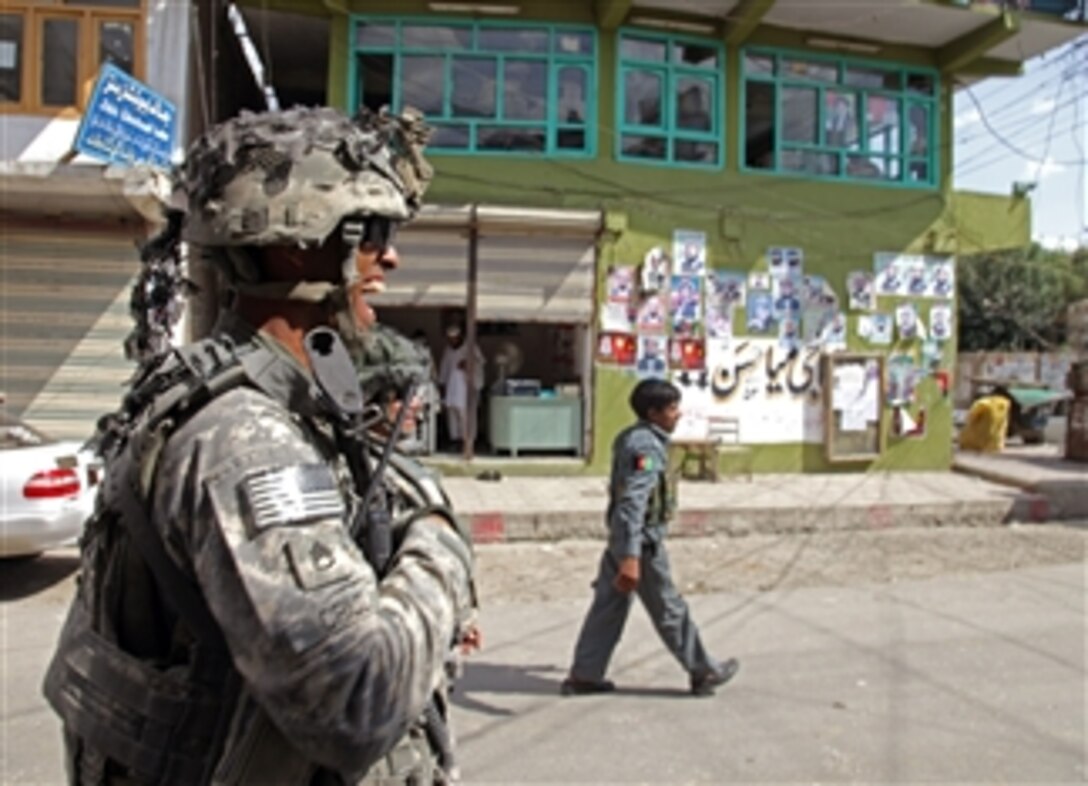 U.S. Army Staff Sgt. Michael Cruz, deployed with 1st Battalion, 32nd Infantry Regiment, patrols with Afghan National Security Forces through the streets of Asadabad city, Konar province, Afghanistan, on Aug. 19, 2009.  