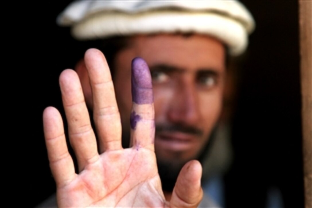 An Afghan elder shows his inked finger to show he voted during the heavily anticipated Afghanistan elections in Barge Matal, Afghanistan, Aug. 20, 2009. Afghanistan village elders are considered to be the role models and leaders among the Afghan civilians. U.S. Army soldiers helped provide security during the elections. 