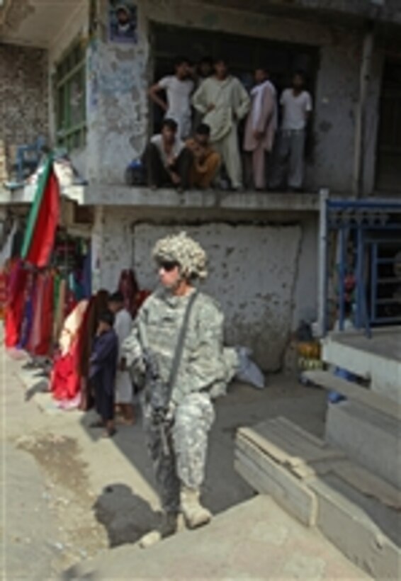 A U.S. Army soldier from 1st Battalion, 32nd Infantry Regiment stands watch during a patrol through the streets of Asadabad city, Konar province, Afghanistan, on Aug. 19, 2009.  