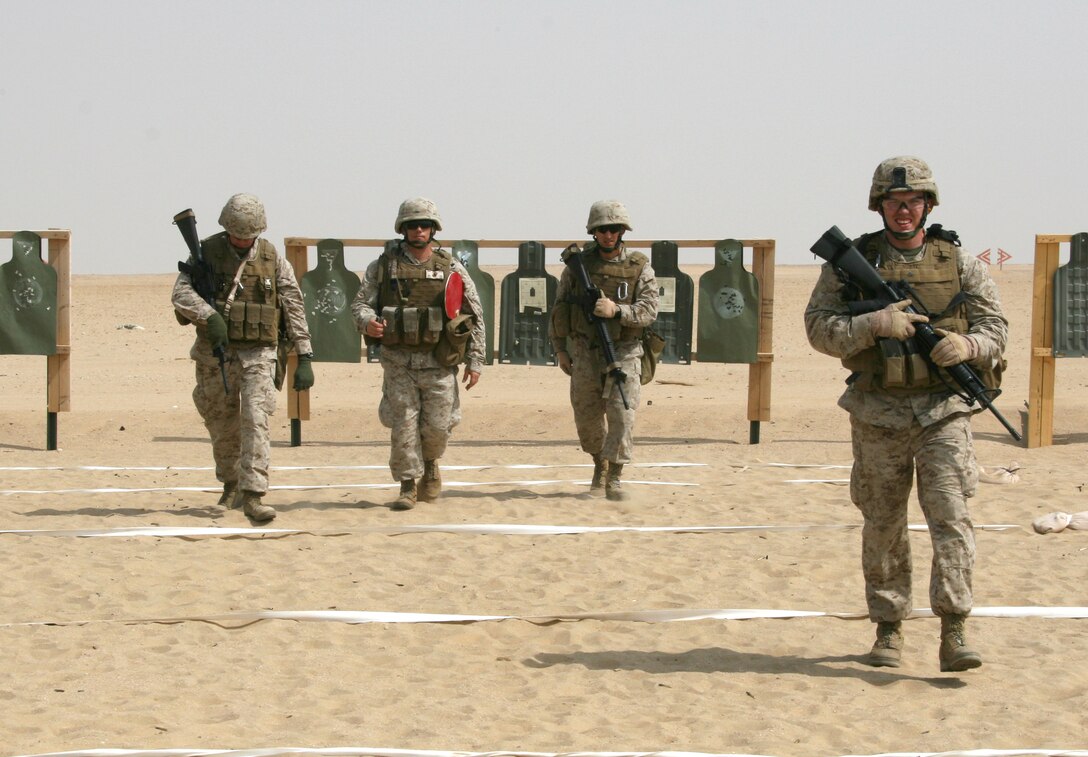 Marines with the 22nd Marine Expeditionary Unit walk back to the firing line after checking their 3-shot groups during the battle-sight zero portion of a Combat Marksmanship Program shoot at a training area near Camp Buehring, Kuwait Aug. 24, 2009. The 22nd MEU is conducting sustainment training ashore in Kuwait while serving as the theater reserve force for U.S. Central Command.