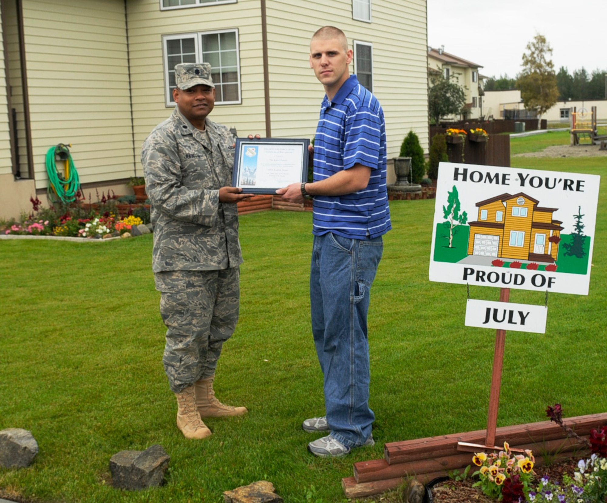 Staff Sgt. Justin Kuntz displays his Home Your Proud of Award with Lt. Col. Jesse Johnson Aug. 18, 2009 Eielson Air Force Base, Alaska. Sergeant Kuntz and his family are winners for area 2. Each winning household received gift cards from various units off base. Sergeant Kuntz is assigned to the 354th Civil Engineering Squadron; Colonel Johnson is the 354th Mission Support Group deputy commander. Not available for a photo was Lt. Col. Russell Smith, 354th Operations Group deputy commander who won HYPO for Area 3.(U.S. Air Force photo/Airman 1st Class Laura Goodgame)