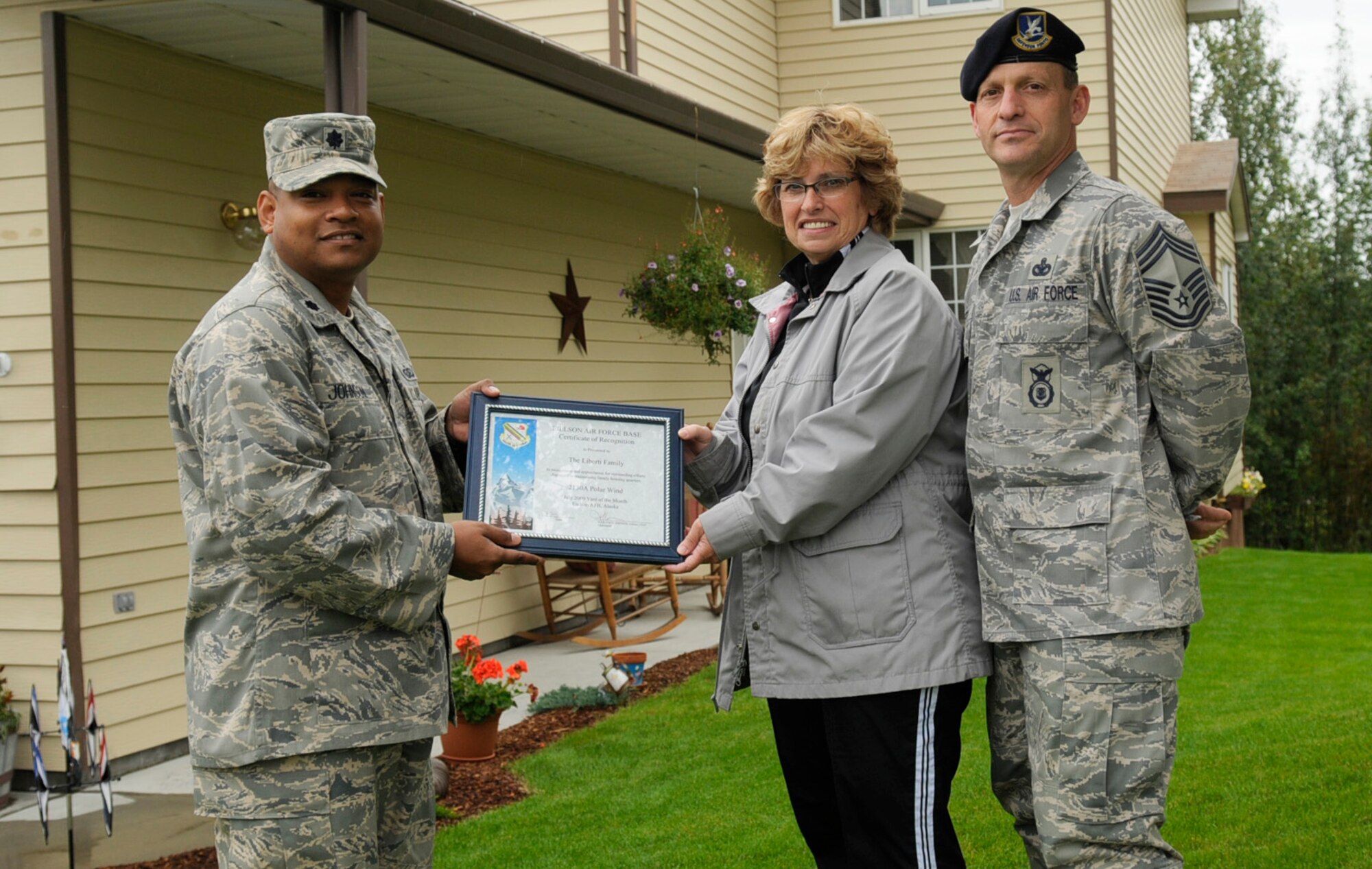 Chief Master Sgt. Nicholas Liberti and wife Gwenn displays their Home Your Proud of Award with Lt. Col. Jesse Johnson Aug. 18, 2009 Eielson Air Force Base, Alaska. Sergeant Liberti and his family are winners for area 1. Each winning household received gift cards from various units off base. Sergeant Liberti is the Security Forces Manager; Colonel Johnson is the 354th Mission Support Group deputy commander. Not available for a photo was Lt. Col. Russell Smith, 354th Operations Group deputy commander who won HYPO for Area 3. (U.S. Air Force photo/Airman 1st Class Laura Goodgame)