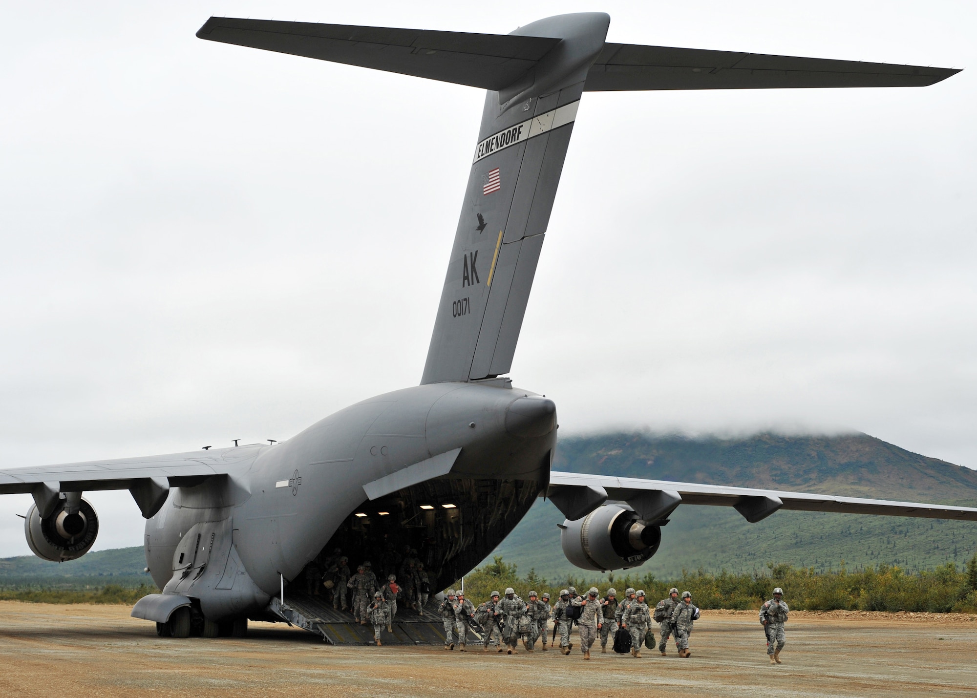 DONNELLY LANDING ZONE, Alaska -- Army Soldiers from the 17th Combat Service Support Battalion on Fort Richardson step off the ramp of a C-17 Globemaster III from the 517th Airlift Squadron at the Donnelly dirt air strip Aug. 24, 2009. The aircraft assisted in deploying 120 Soldiers from Fort Richardson to Donnelly during Arctic Response, an Army Emergency Deployment Readiness Exercise. Two C-17s flew to Donnelly and delivered five pallets, two Humvees, a trailer, and a passenger carrier. (U.S. Air Force photo/Senior Airman Laura Turner)