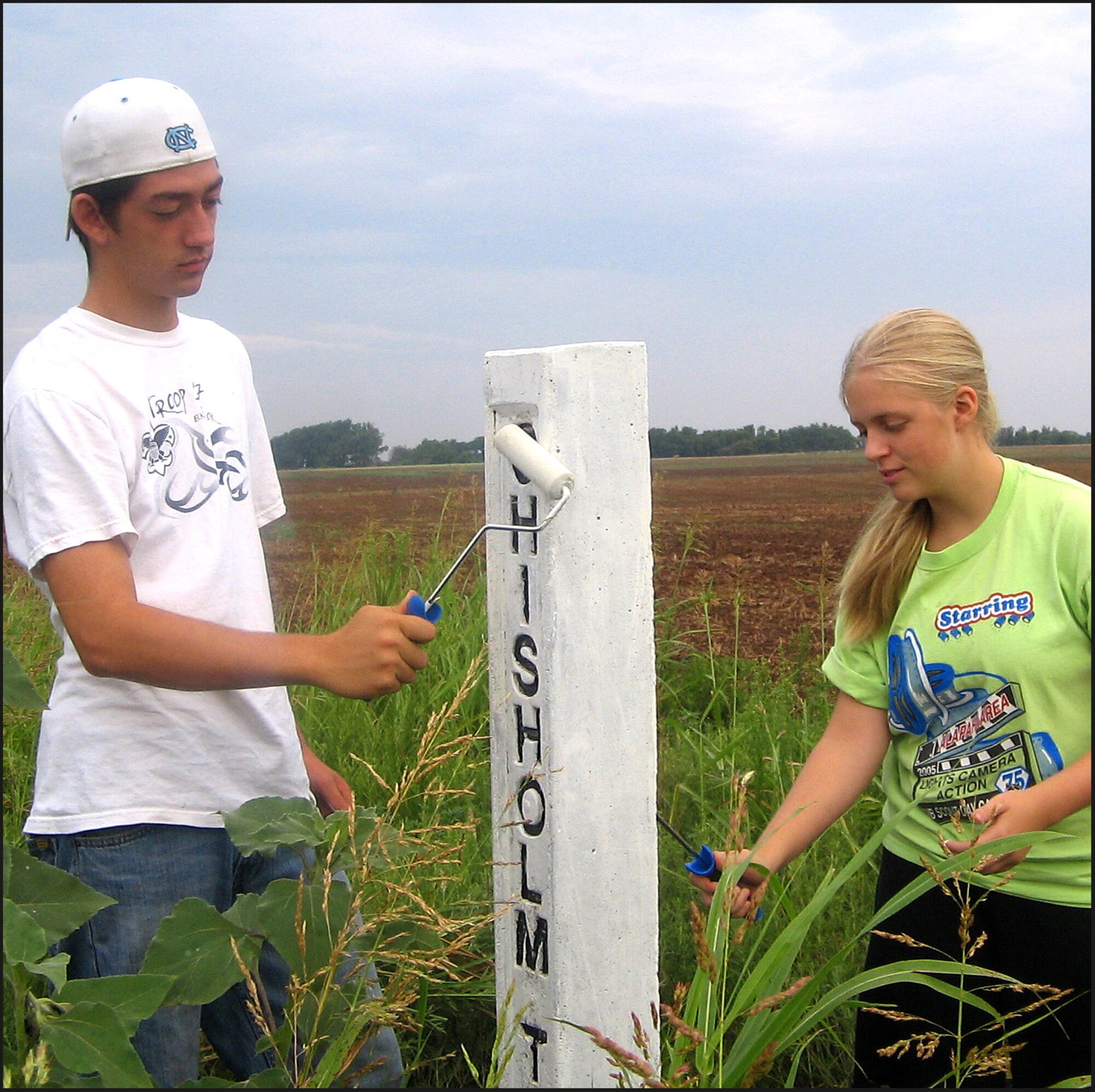 Andy Pyper, left, and Jacklyn Maloy paint one of 28 Chisholm Trail markers that follow the historical cattle-drive route through Grant County, Okla. Andy, son of Maj. Vaughn Pyper of the 25th Flying Training Squadron at Vance AFB, organized the service project to fulfill a requirement for Eagle Scout. Jacklyn is the daughter of Maj. Dan Maloy with the 8th Flying Training Squadron at Vance. Grant County is north of Garfield County where Vance AFB is located. (Photo by Liesl Maloy)