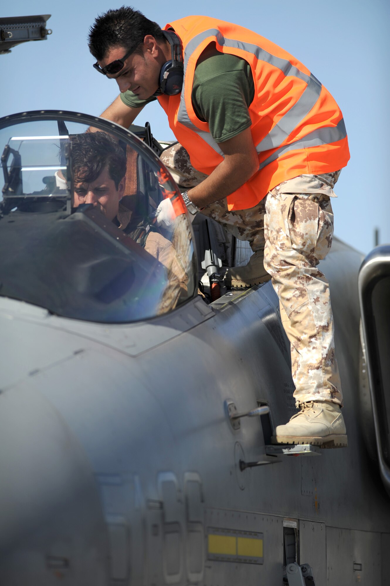 NELLIS AIR FORCE BASE Nev.-- Italian Air Force Crew Chief, Chief Master Sgt. Francesco Alberico, helps strap Capt. Francesco Mariotti into an AMX/A-1 before a training mission at Red Flag 09-5 Aug 24. Before flying in Red Flag, the Italian Air Force participated in their first ever Green Flag—a realistic close air support training exercise for Airmen and Soldiers preparing to deploy in support of combat operations in Southwest Asia. During the two-week exercise held Aug. 7-21, the Italian Air Force worked closely with U.S. Air Force joint terminal attack controllers embedded with the 3rd Infantry Division at Fort Irwin, Calif., to protect 6,000 Soldiers from an opposing enemy force in a 1,000-square-mile combat environment. Red Flag 09-5 ends Sept., 4. (U.S. Air Force photo by Tech. Sgt. Michael R. Holzworth)(Released) 