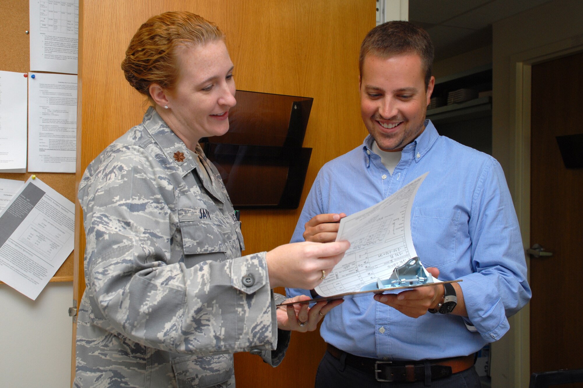 HICKAM AIR FORCE BASE, Hawaii -- Maj. Tara Jayne, 15th Aeromedical-Dental Squadron optometrist, uses a refractor on Senior Airman Matthew Brown to check his eyes after having eye surgery. She has spent more than eight years as an optometrist in the Air Force. Major Jayne, the only Air Force optometrist on Hickam, has been on five humanitarian trips to the Dominican Republic, Philippines and Thailand in her career. Her next assignment will take her to Eastern Europe and Ramstein Air Base, Germany. (U.S. Air Force photo by Staff Sgt. Mike Meares)