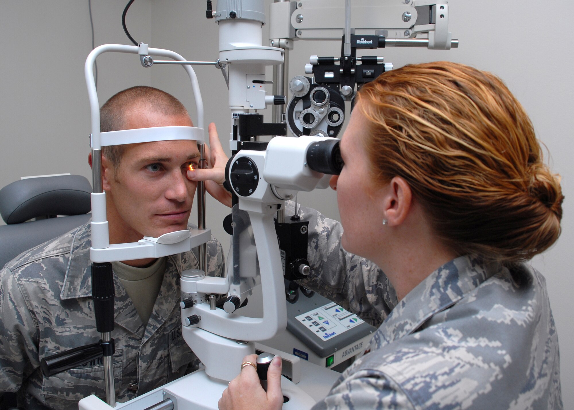 HICKAM AIR FORCE BASE, Hawaii -- Maj. Tara Jayne, 15th Aeromedical-Dental Squadron optometrist, uses a split lamp to determine the overall health of Senior Airman Matthew Brown?s. She has spent more than eight years as an optometrist in the Air Force providing eye care and teaching people that wearing sunglasses can prevent cataracts later in life. Major Jayne, the only Air Force optometrist on Hickam, has been on five humanitarian trips to the Dominican Republic, Philippines and Thailand during her career. Her next assignment will take her to Europe and Ramstein Air Base, Germany. (U.S. Air Force photo by Staff Sgt. Mike Meares)