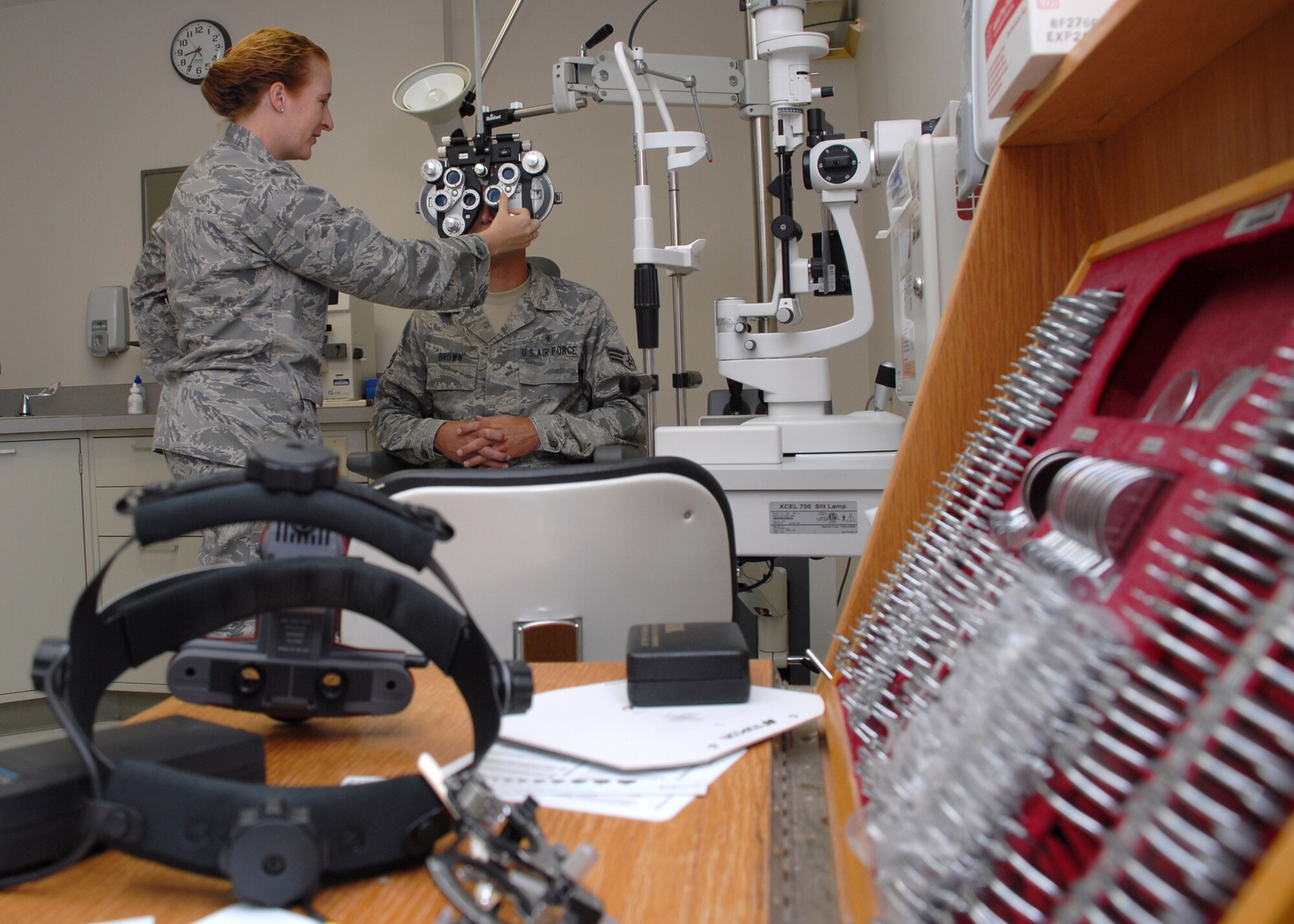 HICKAM AIR FORCE BASE, Hawaii -- Maj. Tara Jayne, 15th Aeromedical-Dental Squadron optometrist, uses a refractor on Senior Airman Matthew Brown to check his eyes after having eye surgery. She has spent more than eight years as an optometrist in the Air Force. Major Jayne, the only Air Force optometrist on Hickam, has been on five humanitarian trips to the Dominican Republic, Philippines and Thailand in her career. Her next assignment will take her to Eastern Europe and Ramstein Air Base, Germany. (U.S. Air Force photo by Staff Sgt. Mike Meares)