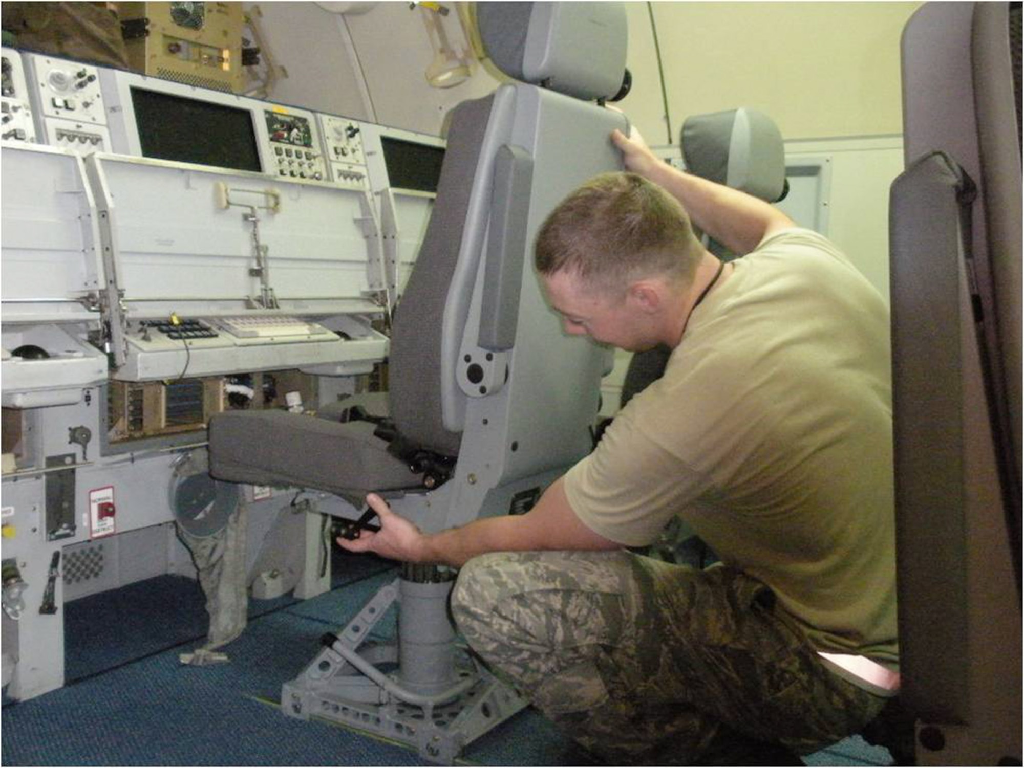 A maintenance crewmember at Tinker Air Force Base, Okla., installs a new operator stations seat aboard an E-3 Sentry recently. The new seats are expected to help alleviate back and neck stress for crews on long-duration missions. (Courtesy photo)