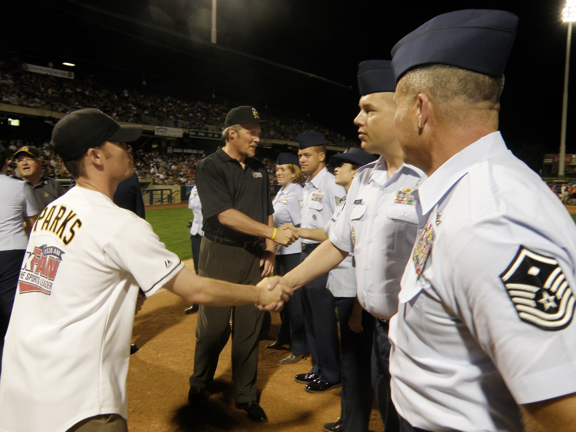 Tony Parks and Mr. Greg Miller (rear) of the Salt Lake Bees Triple-A baseball team, thank members of the 368th Recruiting Squadron for their service. The Bees were presented Air Force Recruiting Service's top civic award, the American Spirit Award, following the game Aug. 22, at Spring Mobile Park in Salt Lake City, Utah. (U.S. Air Force photo/Christa D'Andrea)