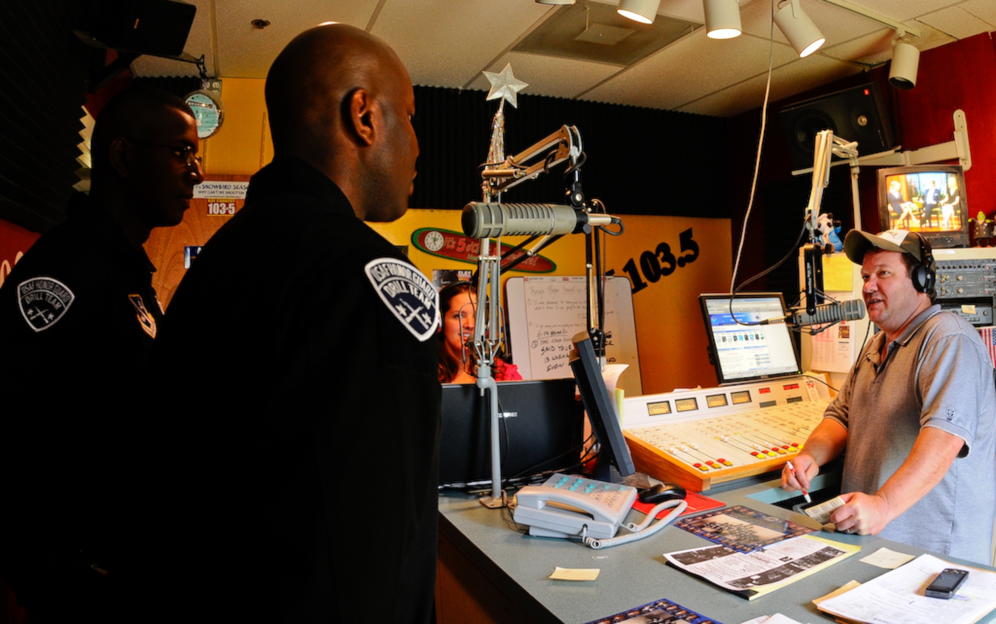 Airman 1st Class Jason Ruffin and Master Sgt. Steven West, United States Air Force Honor Guard Drill Team, make a guest appearance with Rob Stark of Kat Country Radio Aug. 19 in Panama City, Fla. The team performs on military installations and in local communities during their Florida tour, showcasing Air Force professionalism and teamwork. (U.S Air Force photo by Senior Airman Alexandre Montes)