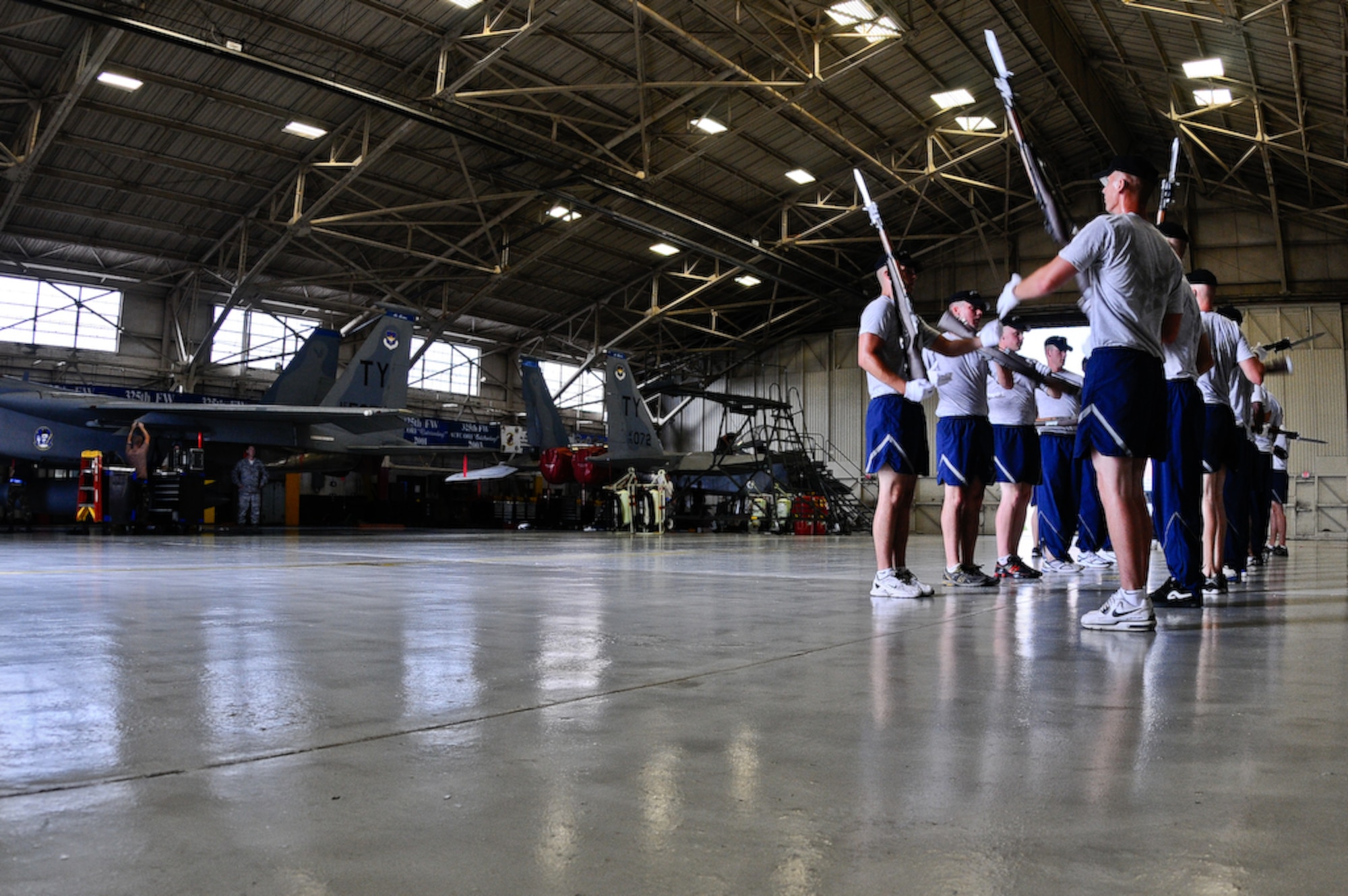 The United States Air Force Honor Guard Drill Team holds a practice inside a hangar, Aug. 21 on Tyndall Air Force Base, Fla. Any down time Drill Team members have is filled with training and practice to maintain the precision they are known for. The team performs on military installations and in local communities during their Florida tour, showcasing Air Force professionalism and teamwork. (U.S Air Force photo by Senior Airman Alexandre Montes)