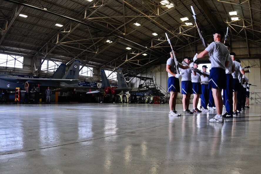 The United States Air Force Honor Guard Drill Team holds a practice inside a hangar, Aug. 21 on Tyndall Air Force Base, Fla. Any down time Drill Team members have is filled with training and practice to maintain the precision they are known for. The team performs on military installations and in local communities during their Florida tour, showcasing Air Force professionalism and teamwork. (U.S Air Force photo by Senior Airman Alexandre Montes)