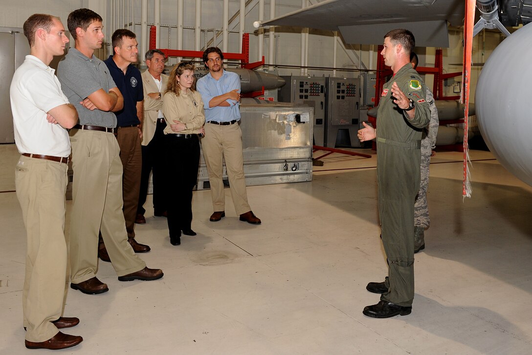 LANGLEY AIR FORCE BASE, Va. -- Capt. John Newman, 71st Fighter Squadron F-15 Eagle pilot, points out features on the F-15 to military legislative assistants here Aug 21.  The F-15 was one of many stops for the assistants as they toured Langley. (U.S. Air Force photo/Airman 1st Class Gul Crockett)
