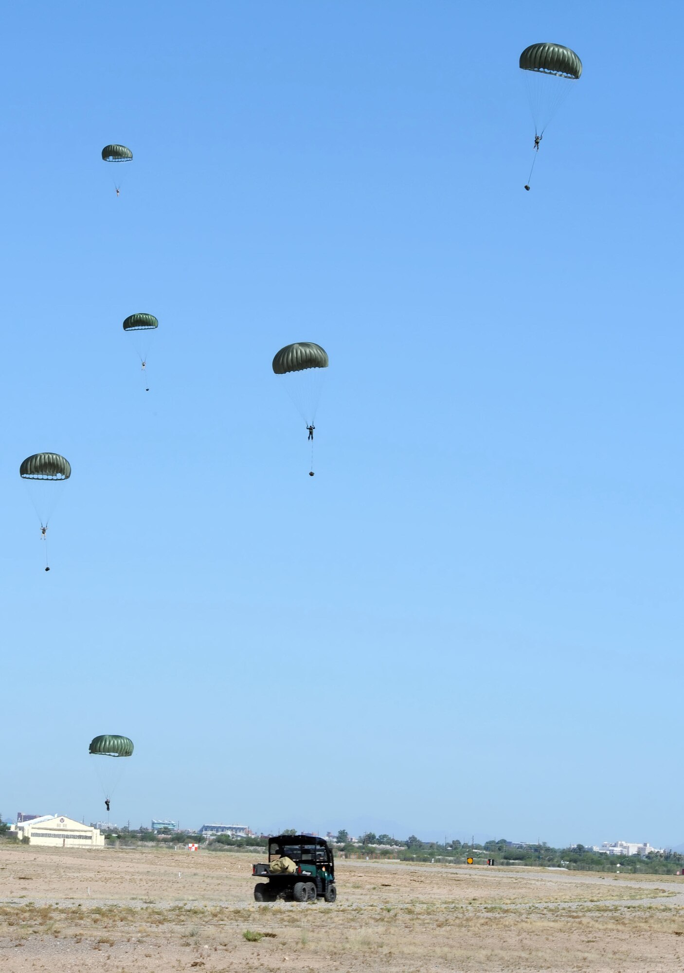 Airmen from the 306th Rescue Squadron, parachute out of a HC-130 at
Davis-Monthan Air Force Base, Ariz., Aug. 15, 2009.  The Airmen were
participating with  the 79th Rescue Squadron in the first multi-lift HC-130
airdrop here.  Usually the members have to use another facility to conduct
the drops. They were able to accomplish seven drops from different
altitudes. ( U.S. Air Force Photo by:  Senior Airman Jacqueline Romero)
