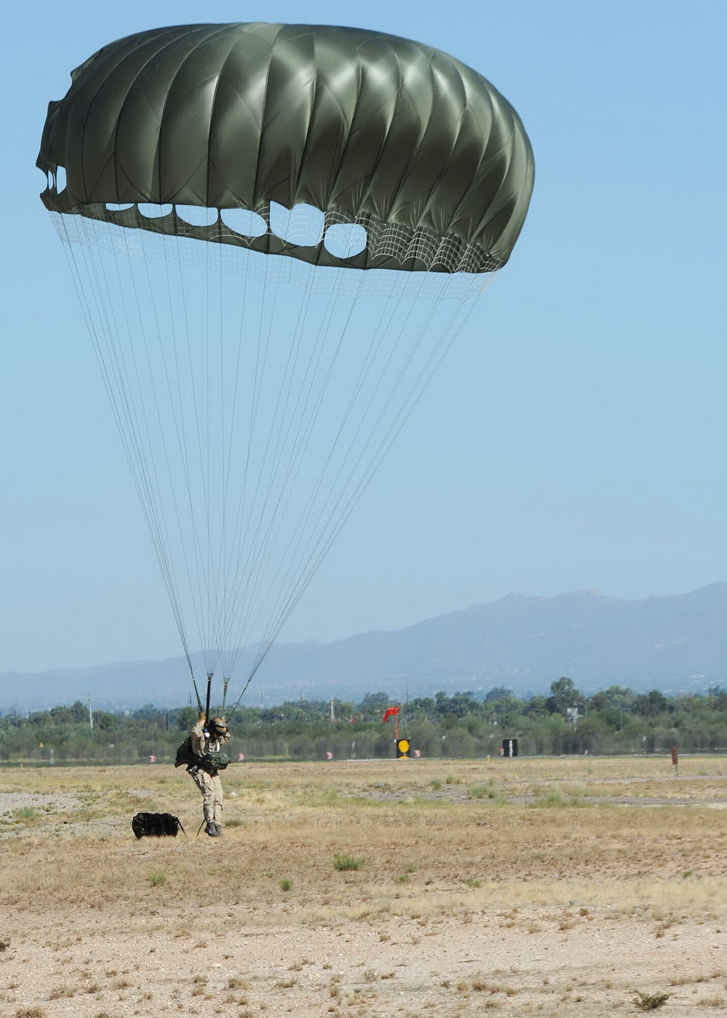 Tech. Sgt. Sean McBride, 306th Rescue Squadron, lands safely on the drop zone
at Davis-Monthan Air Force Base, Ariz., Aug. 15, 2009. Sergeant McBride was
participating with members of the 306th RS and the 79th Rescue Squadron in
the first multi-lift HC-130 airdrop here. Usually the members have to use
another facility to conduct the drops. They were able to accomplish seven
drops from different altitudes. ( U.S. Air Force Photo by:  Senior Airman
Jacqueline Romero)
