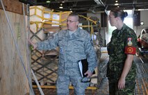 Senior Master Sgt. Dan Schultz, NCO in charge of the 46th APS ramp section here, discusses aerial port operations with Canadian Air Force Warrant Officer April Roach of the 2 Air Movements Squadron, a unit of the 8 Wing Canadian Forces Base Trenton, Aug. 24.  Several reservists from the 512th Airlift Wing visited the Canadian Air Force base Aug. 22-24 to forge a partnership and identify future training opportunities for flying, aerial port, airlift control and maintenance operations. (U.S. Air Force photo/Capt. Marnee A.C. Losurdo)